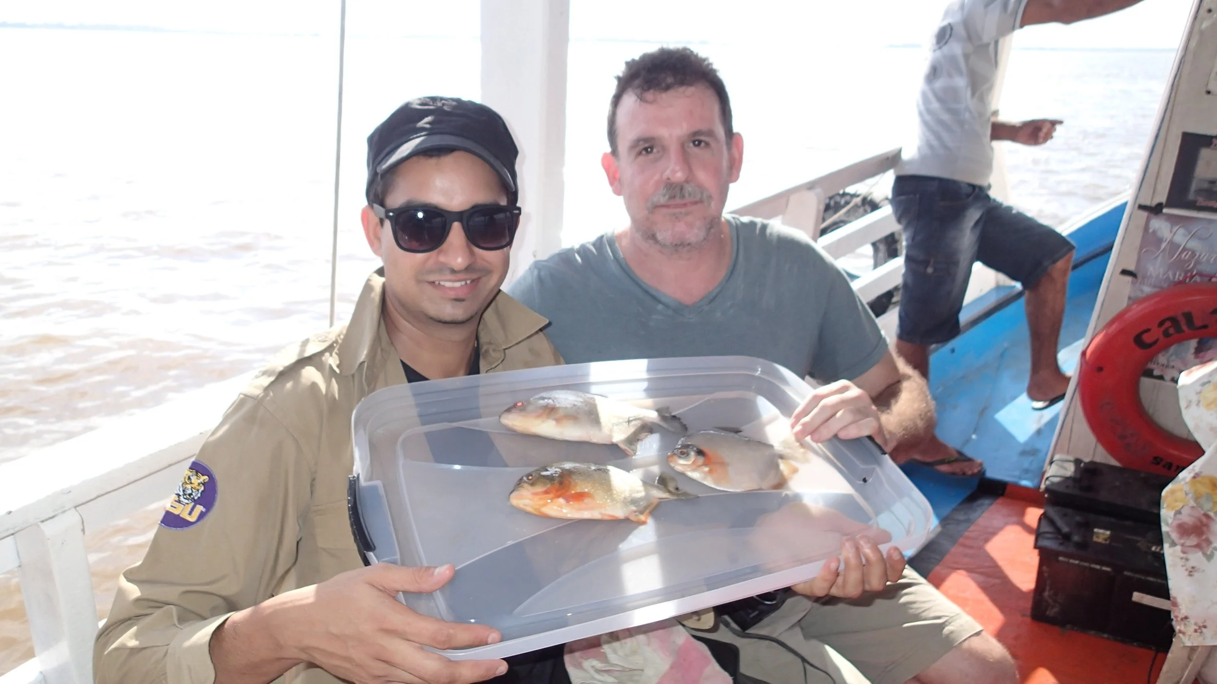 A photo of Prosanta Chakrabarty and collaborator James Albert with fish they collected during a field expedition on the Brazilian Amazon.
