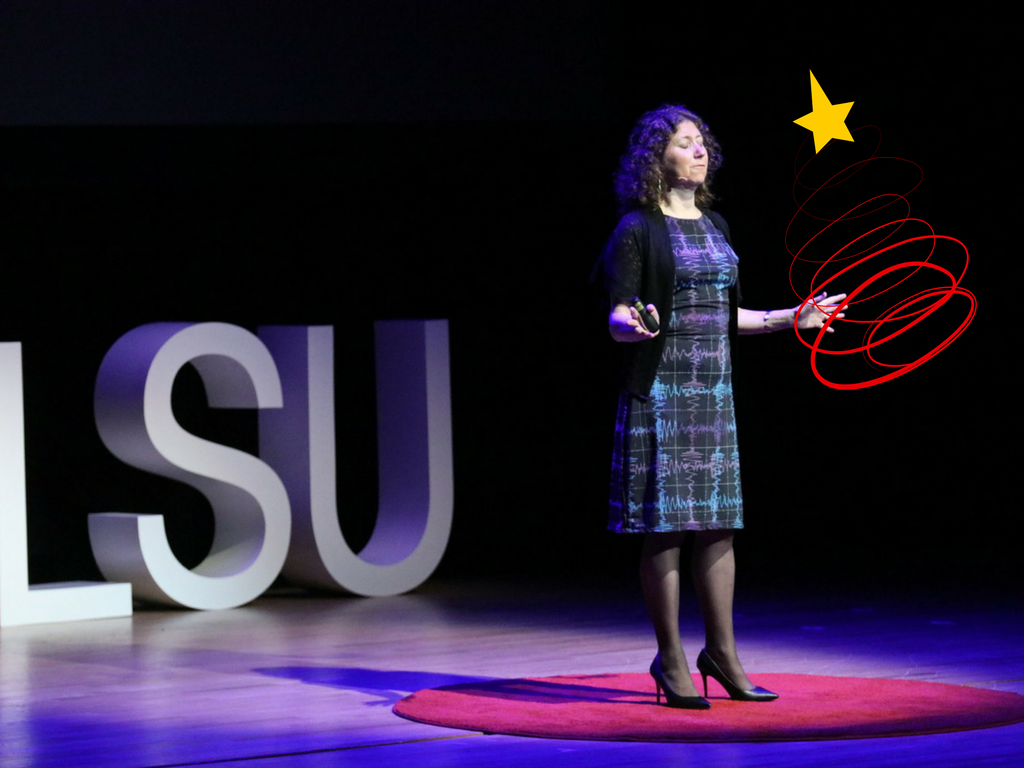 Photo of Gaby talking about gravitational waves at TEDxLSU. Credit: TEDxLSU.