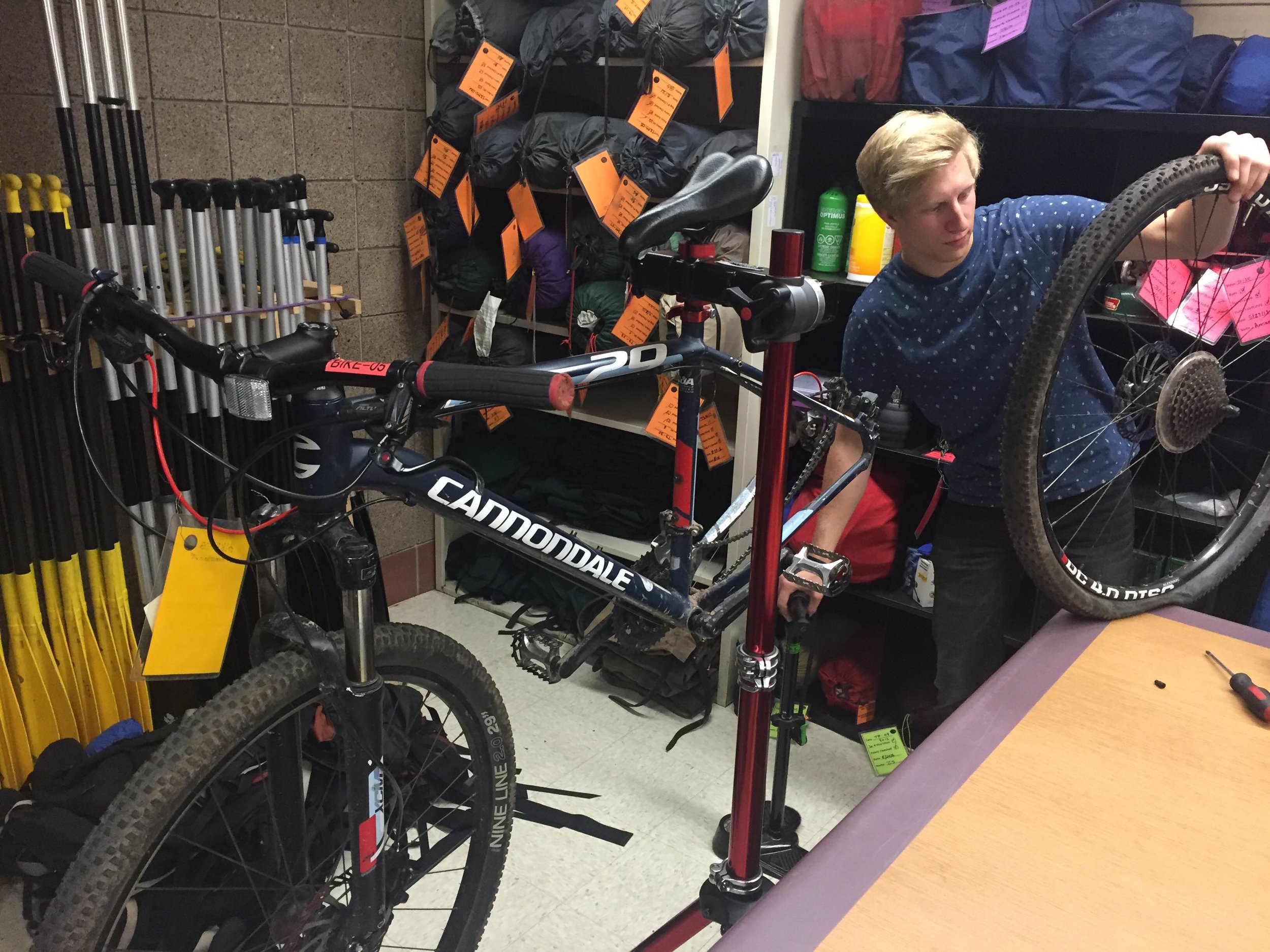 UMD Rental Center staff member Phill Huss works on a mountain bike