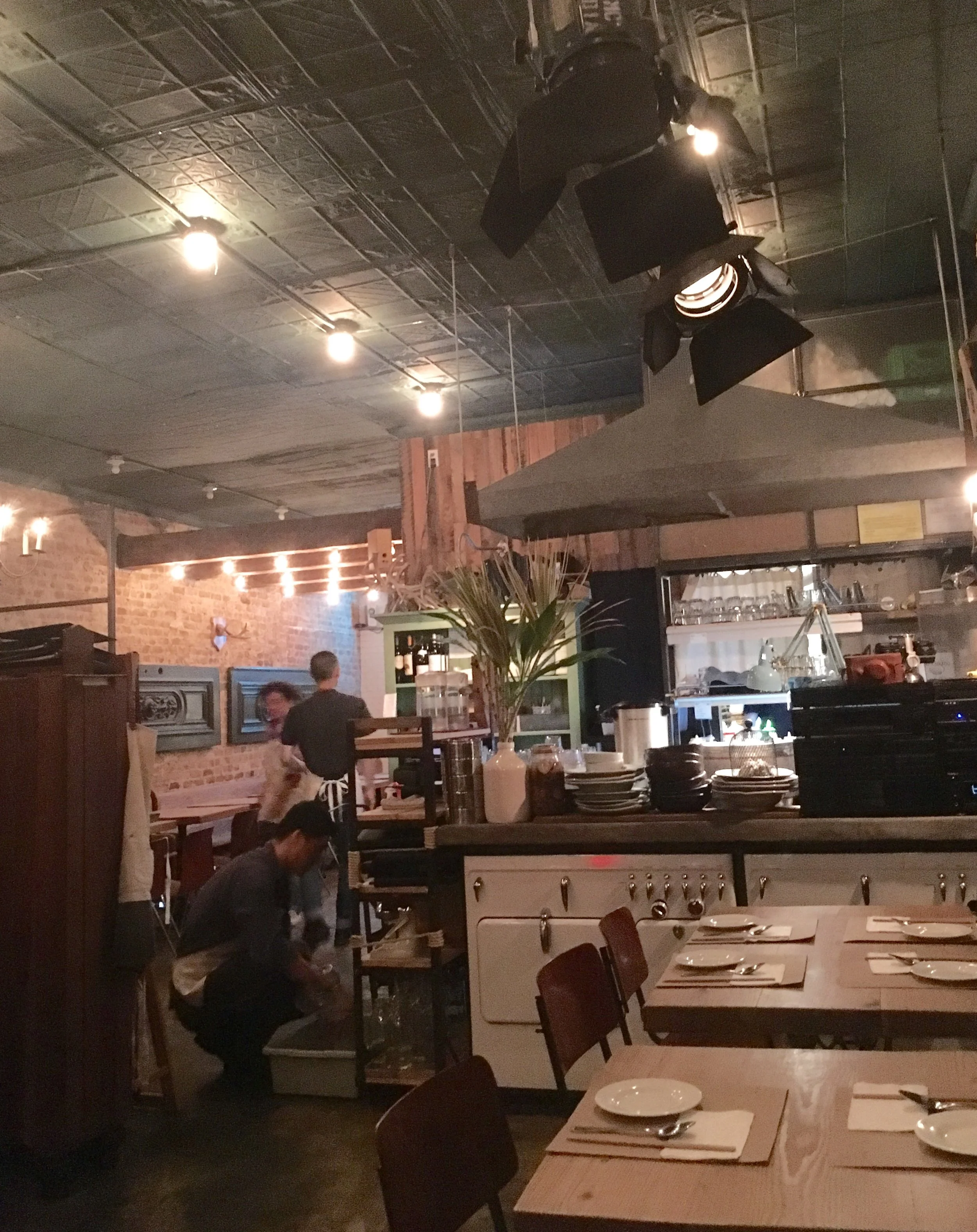 The dining room. Super cute decor with custom stage track lighting and old school ovens. 
