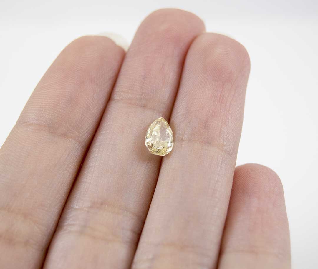canary diamond 1.00 pear in hand.jpg