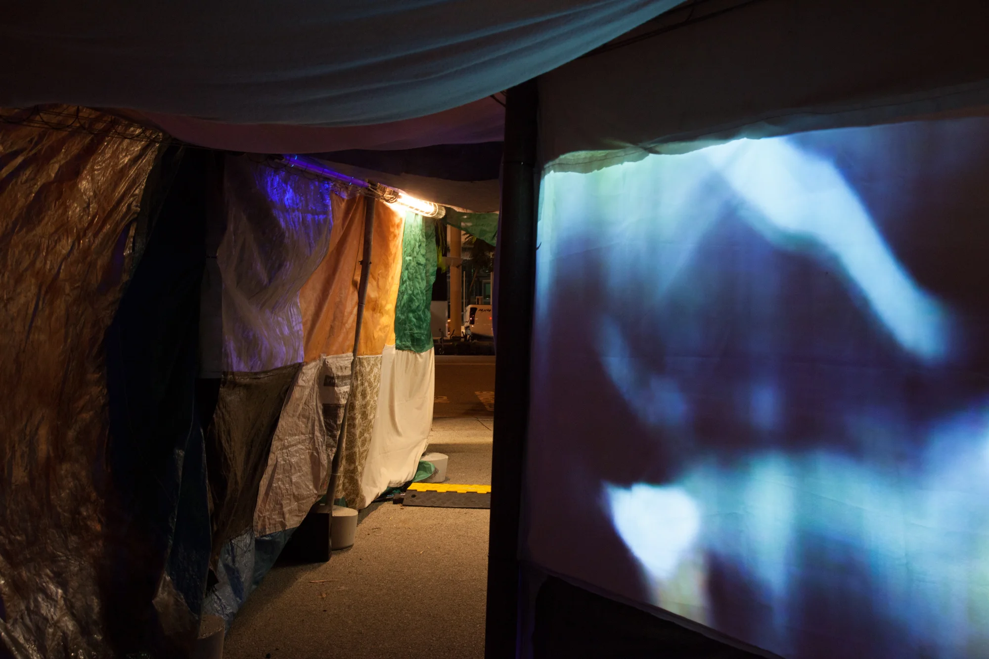 Slushbox , tunnel made from salvaged fabrics, Neil Aldum, Erin Coates and Simone Johnston. Undergo , video projection inside tunnel, Loren Holmes Photography: Yvonne Doherty