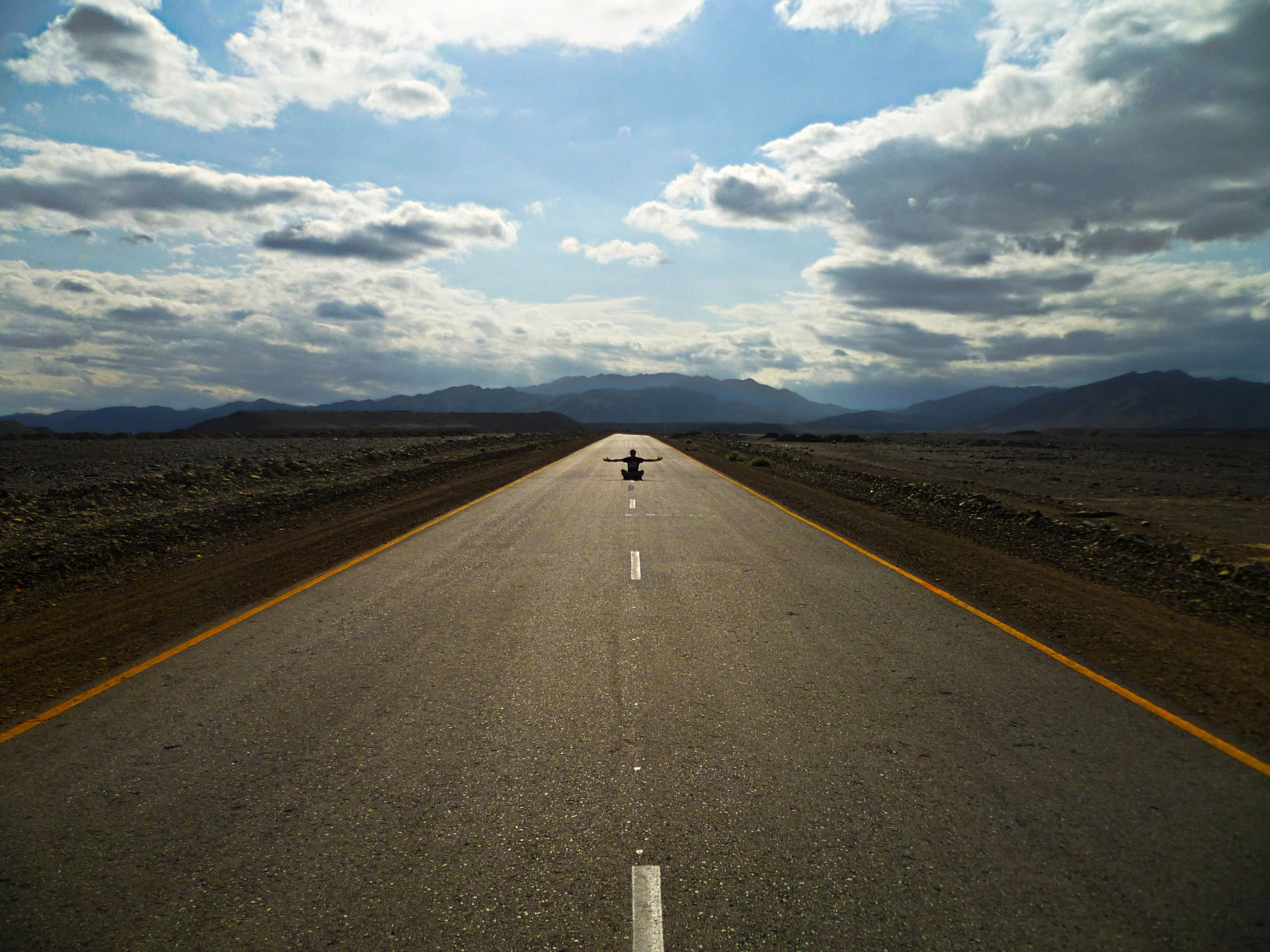 Perfect strips of tarmac stretch deep into the otherwise empty landscape...