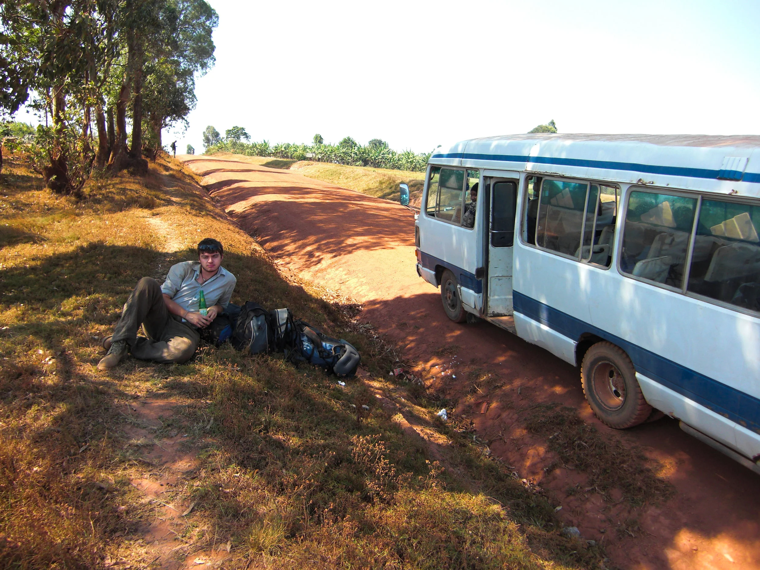 Celebrating having just crossed the border from Burundi into Tanzania with a cold drink next to another trusty local bus…