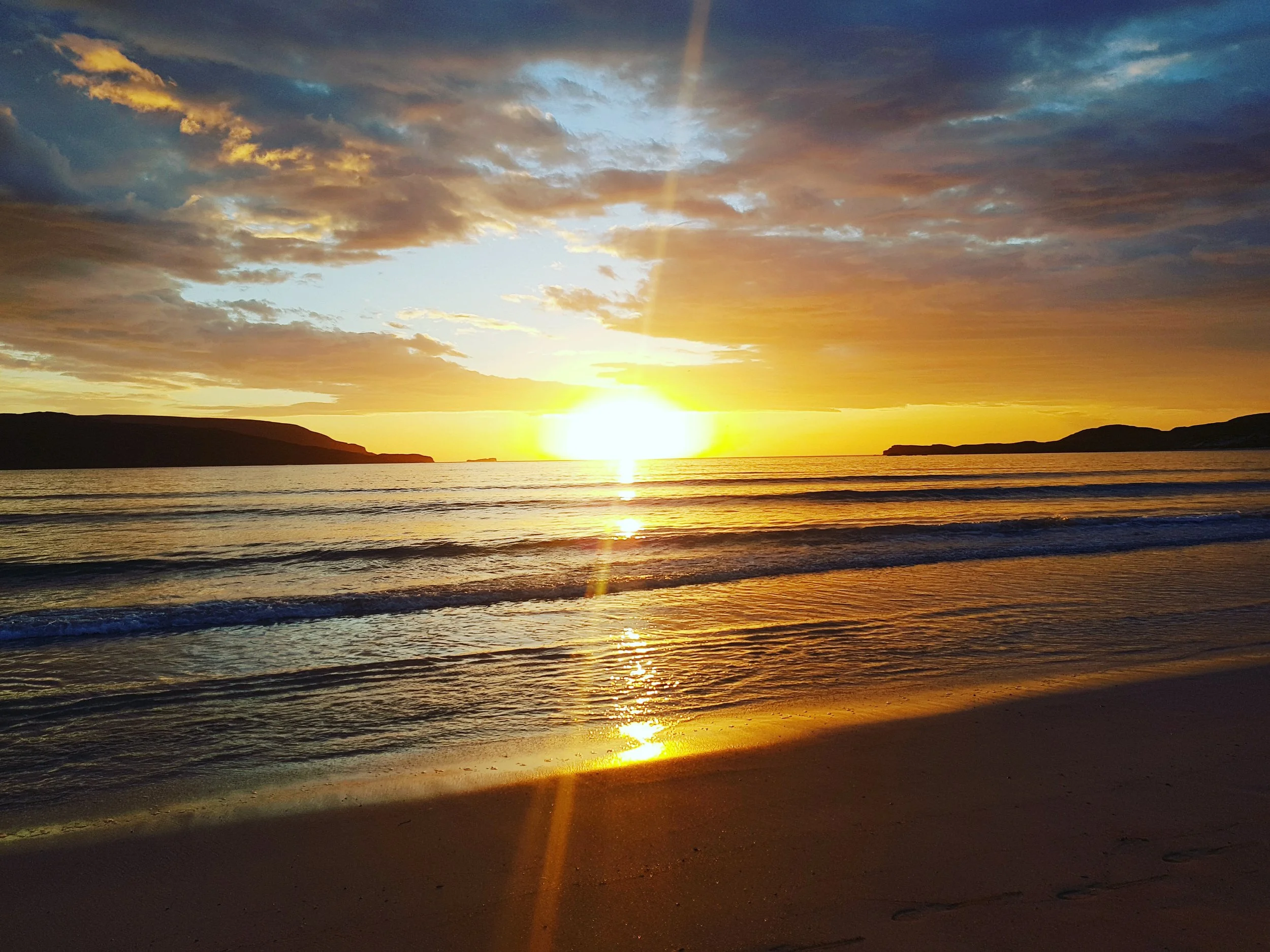 Sunset July Durness Balnakeil beach golden and dramatic across water and sand