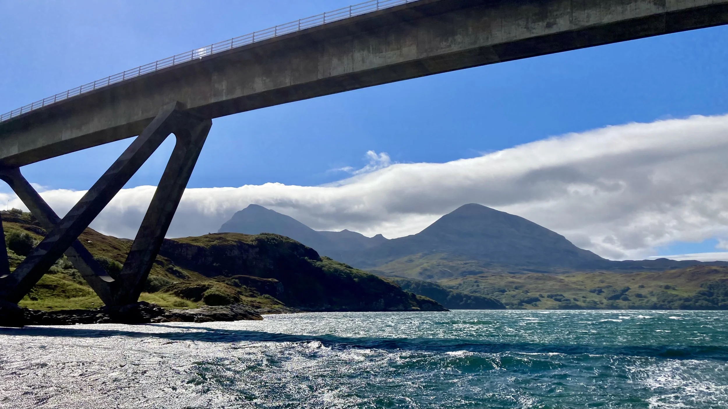 Kylesku bridge from sea, Quinaig peaks in background