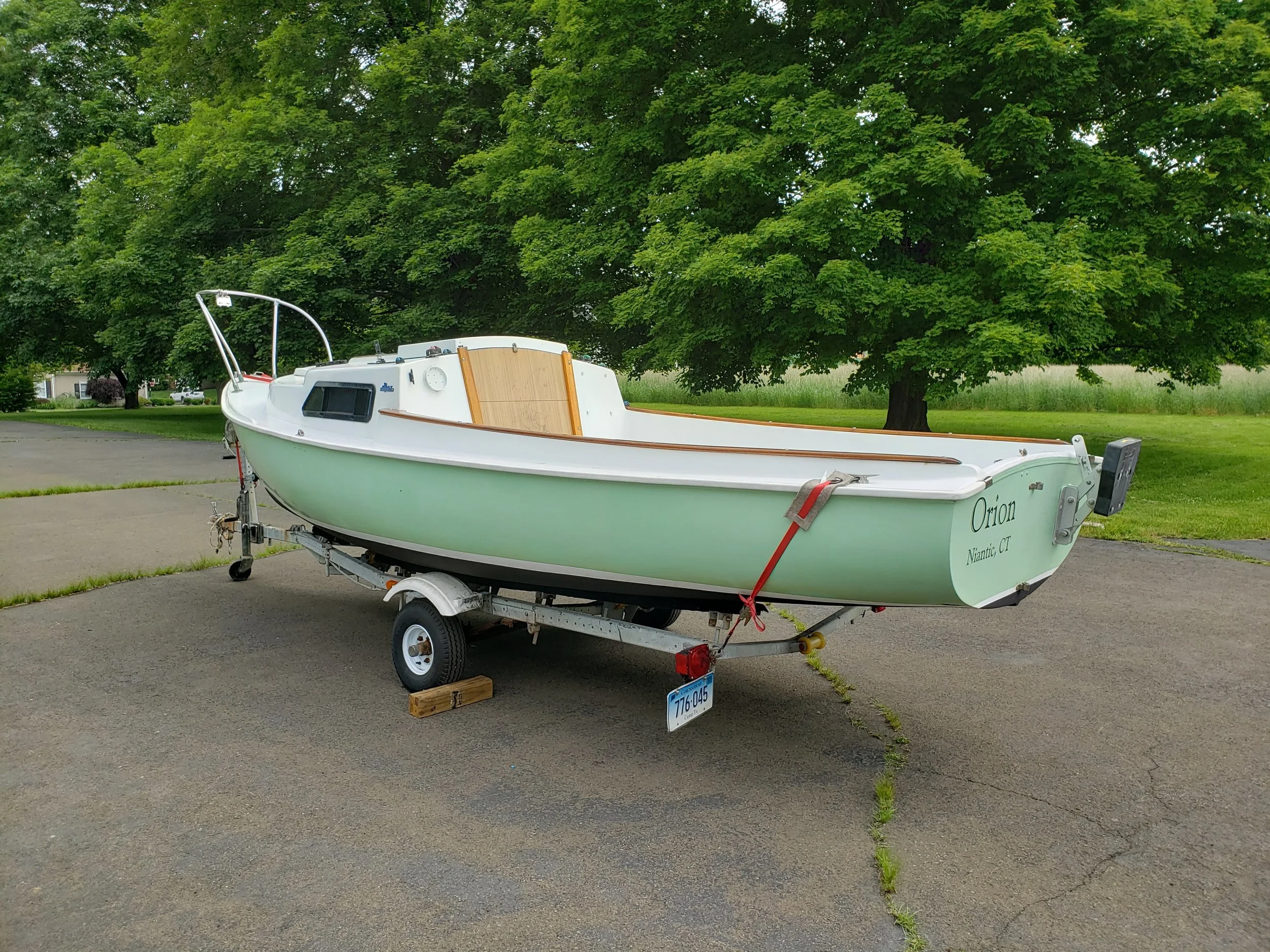 June 5th: ORION finally emerged from her garage to be trailered up to Niantic. Over the winter, she received new bottom paint (which will last three years), new bootstripe paint, and two fresh coats of varnish on all the wood.