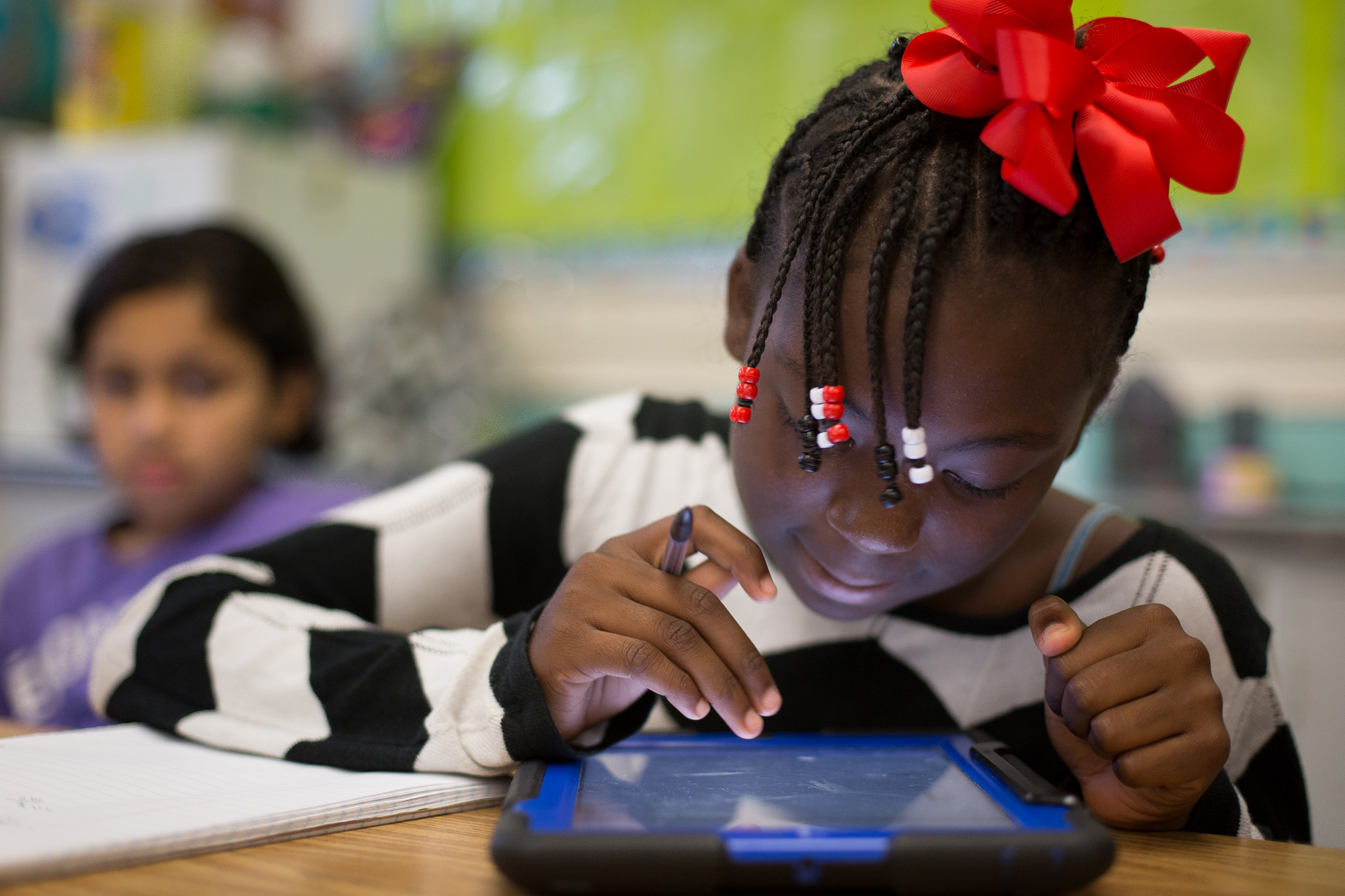  Donjana Wilson, 11, uses a tablet in Virginia Stanfield’s 5th-grade math class. Federal grants have enabled each student to have access to tablets at the Parkview. 
