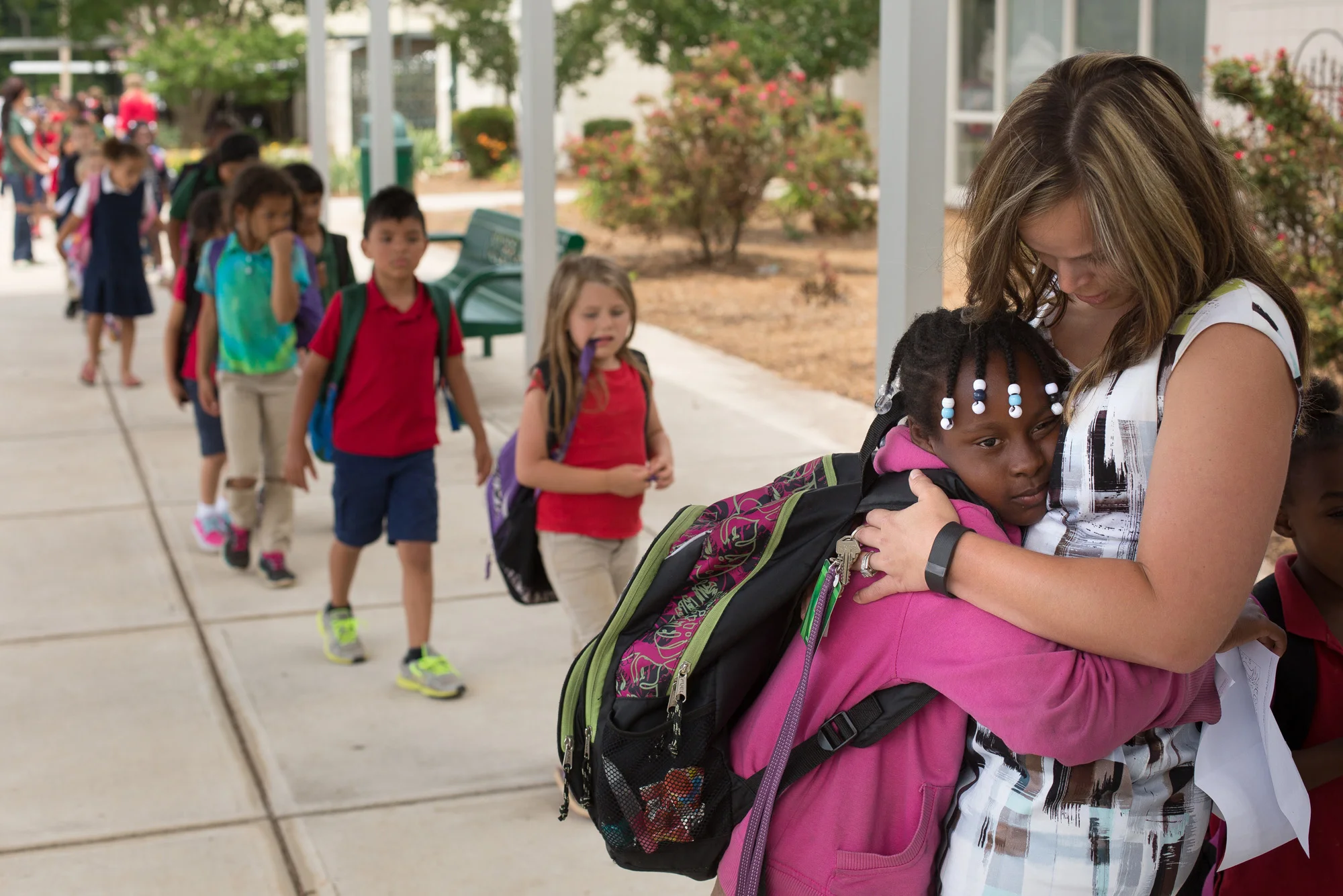  Janna Sells hugs 3rd grade student Shamonica Branch at the end of the school day at East Iredell. 