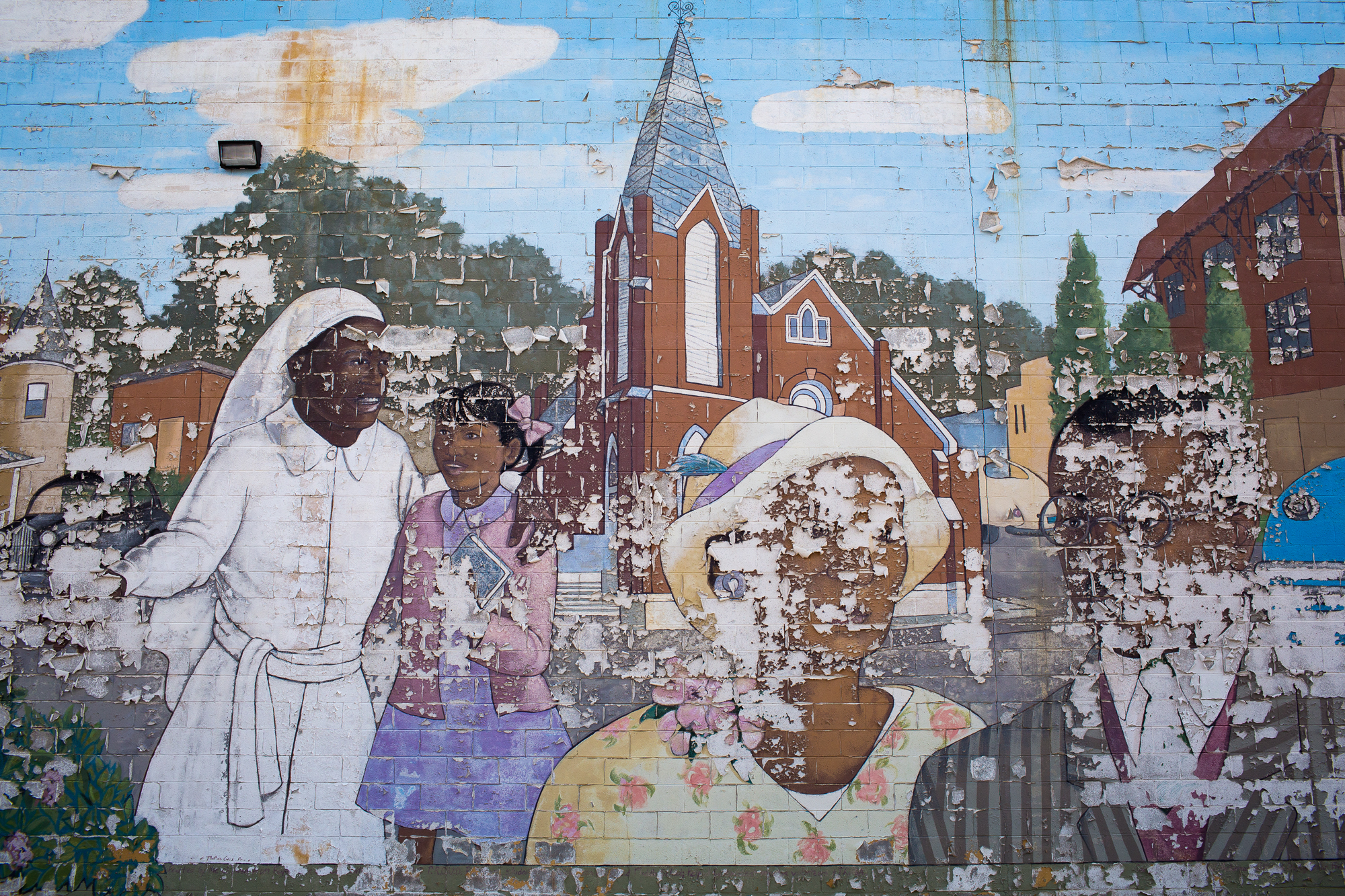  A mural of Durham’s historic African-American Hayti Community at the Heritage Square shopping center is disintegrating. Older residents say Hayti was ruined in the 1960s and 1970s by urban renewal projects including the Durham Freeway, which cut off