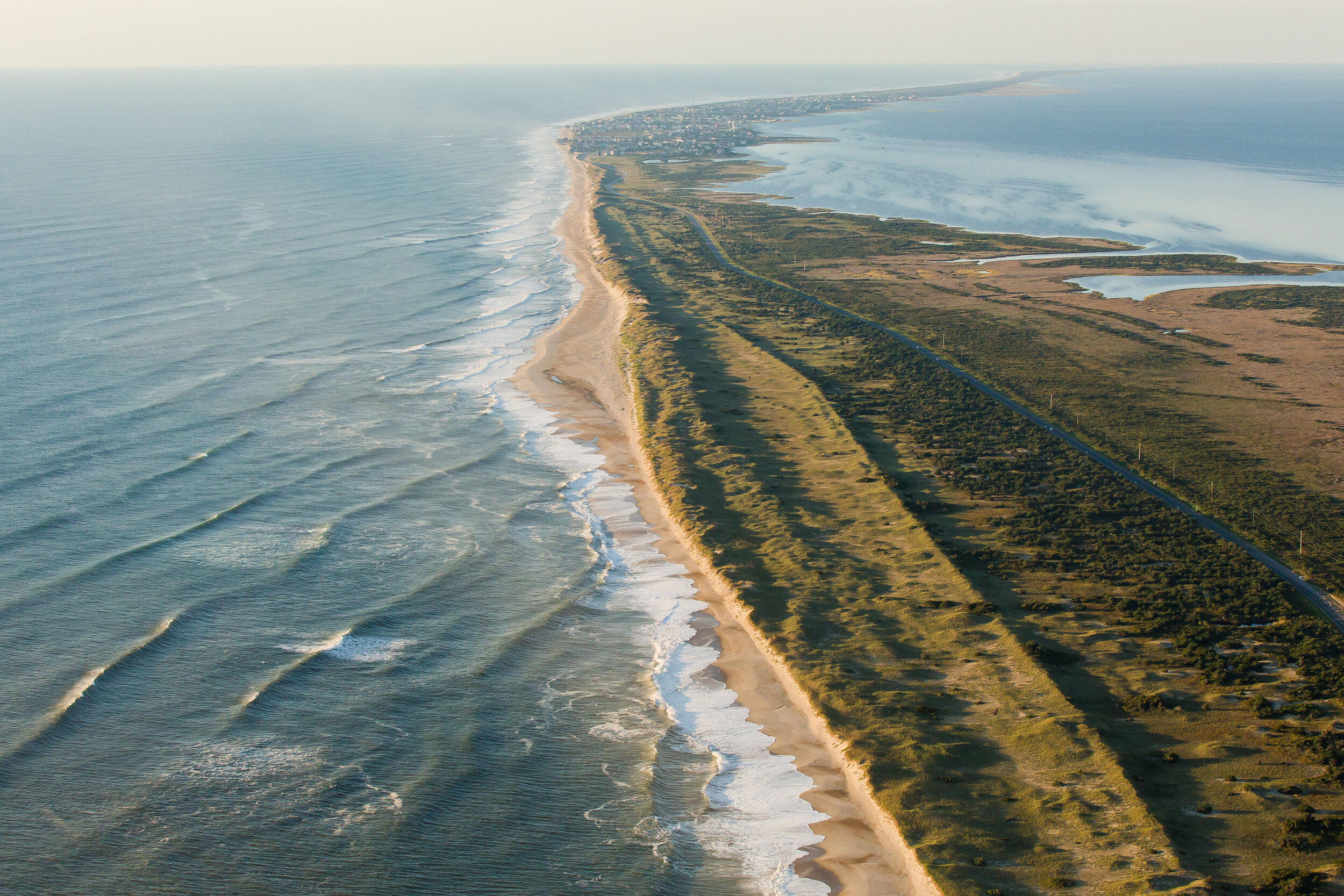  The Atlantic barrier dune ridges and N.C. Highway 12 on Pea Island, looking south towards the villages of Rodanthe, Waves and Salvo. These thin barrier islands are built, sustained and reshaped by storm surge during hurricanes and other violent stor