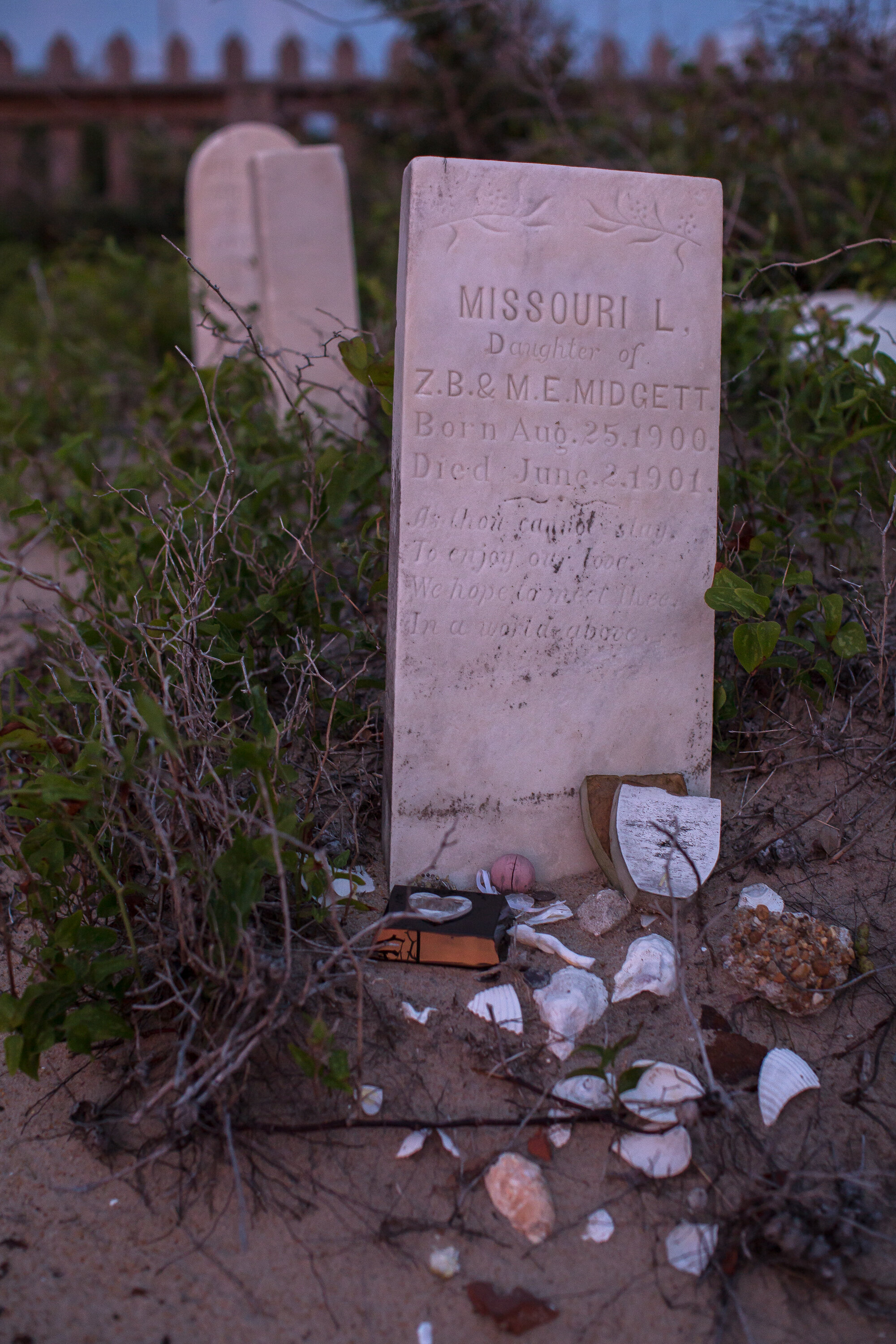  Tributes left behind on the grave of Missouri L. Midgett, who died at 10-months old in 1901. 