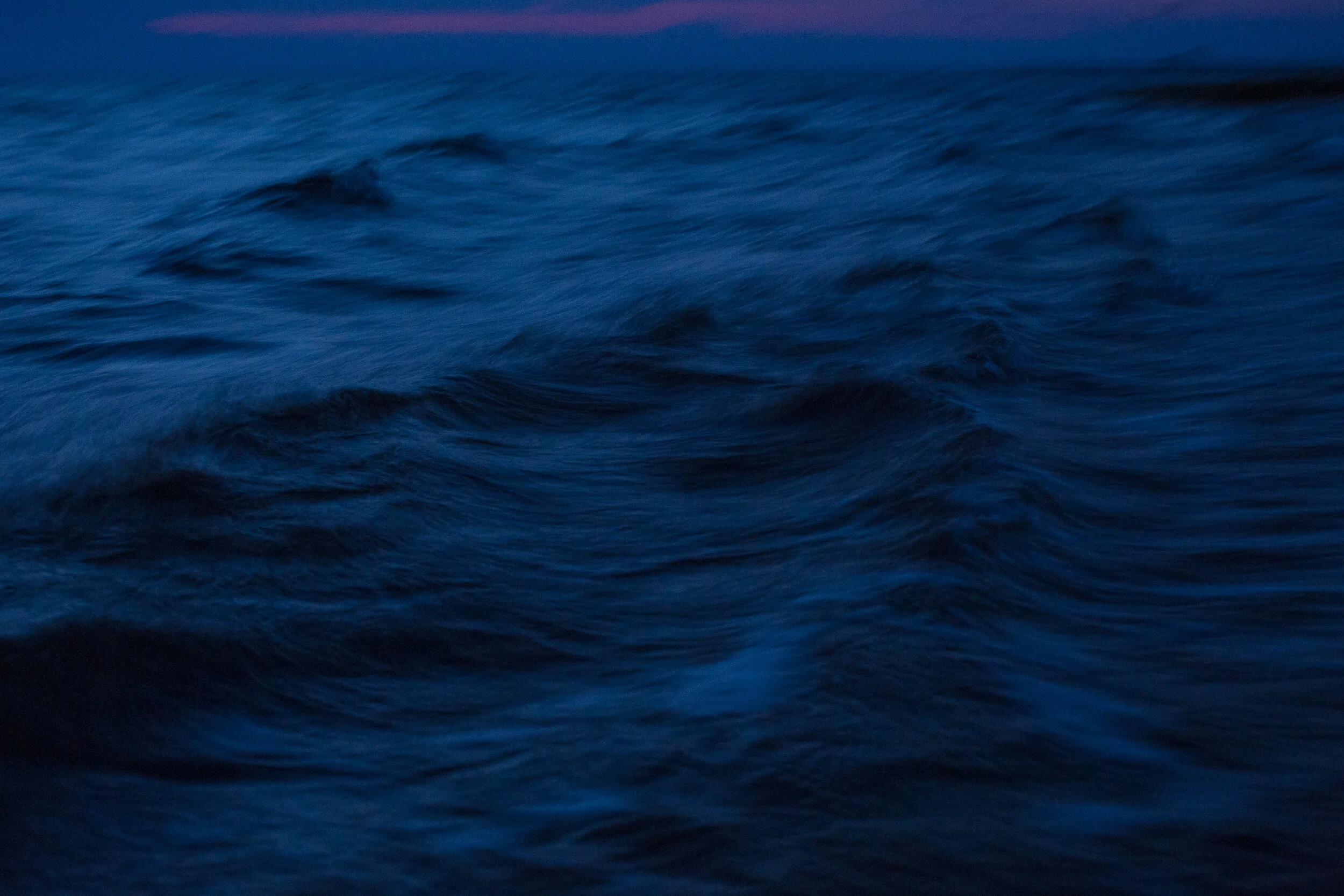  The Pamlico Sound at the edge of the Salvo Community Cemetery is whipped up by a strong southwest wind at twilight. Rachel Carson said it best:  “In its mysterious past [the sea] encompasses all the dim origins of life and receives in the end, after