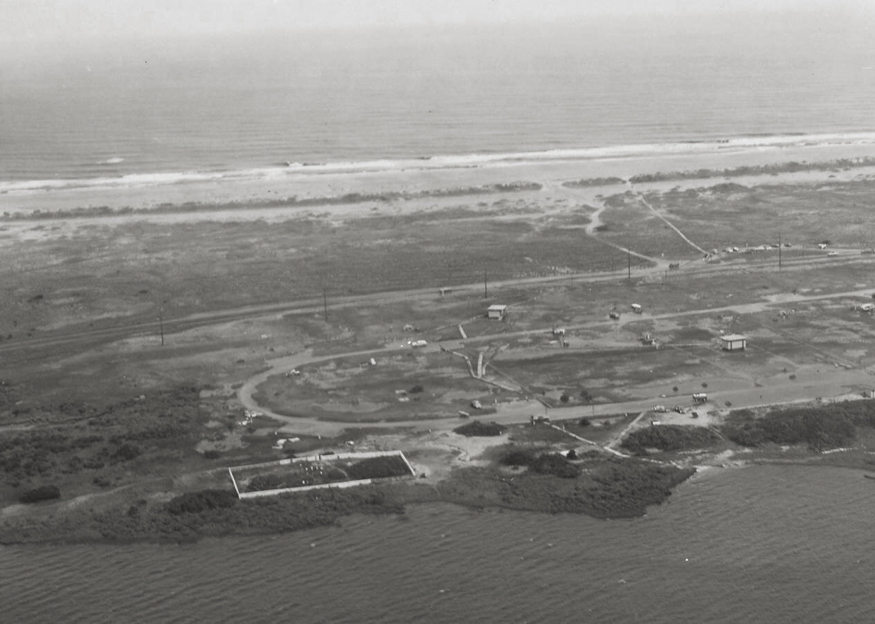 The Salvo Community Cemetery in 1970, with a complete fence and a shoreline with vegetation.  Photo  c ourtesy of National Park Service, Cape Hatteras National Seashore  