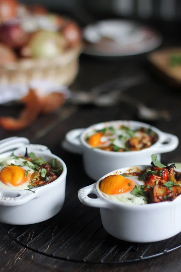Harissa baked eggs with goat cheese, sweet potato & veggies