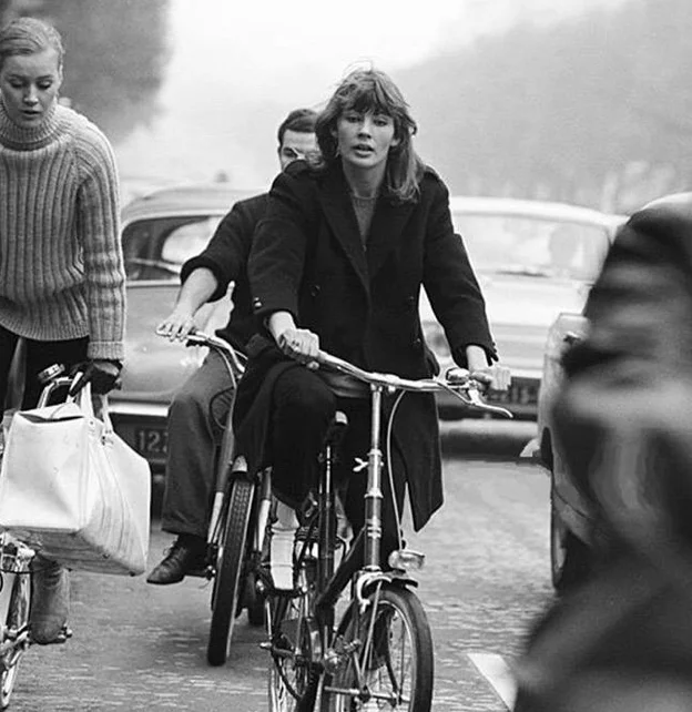 FRANCOISE HARDY RIDING A BICYCLE IN PARIS