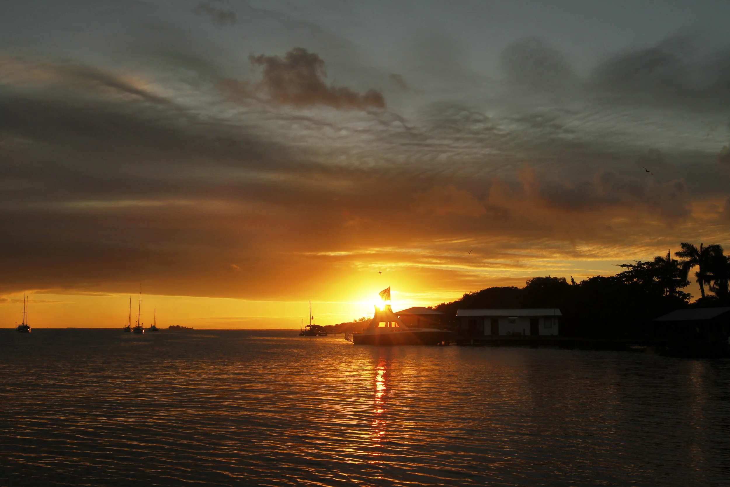 A striking sunset fills the sky over the Placencia Peninsula. 