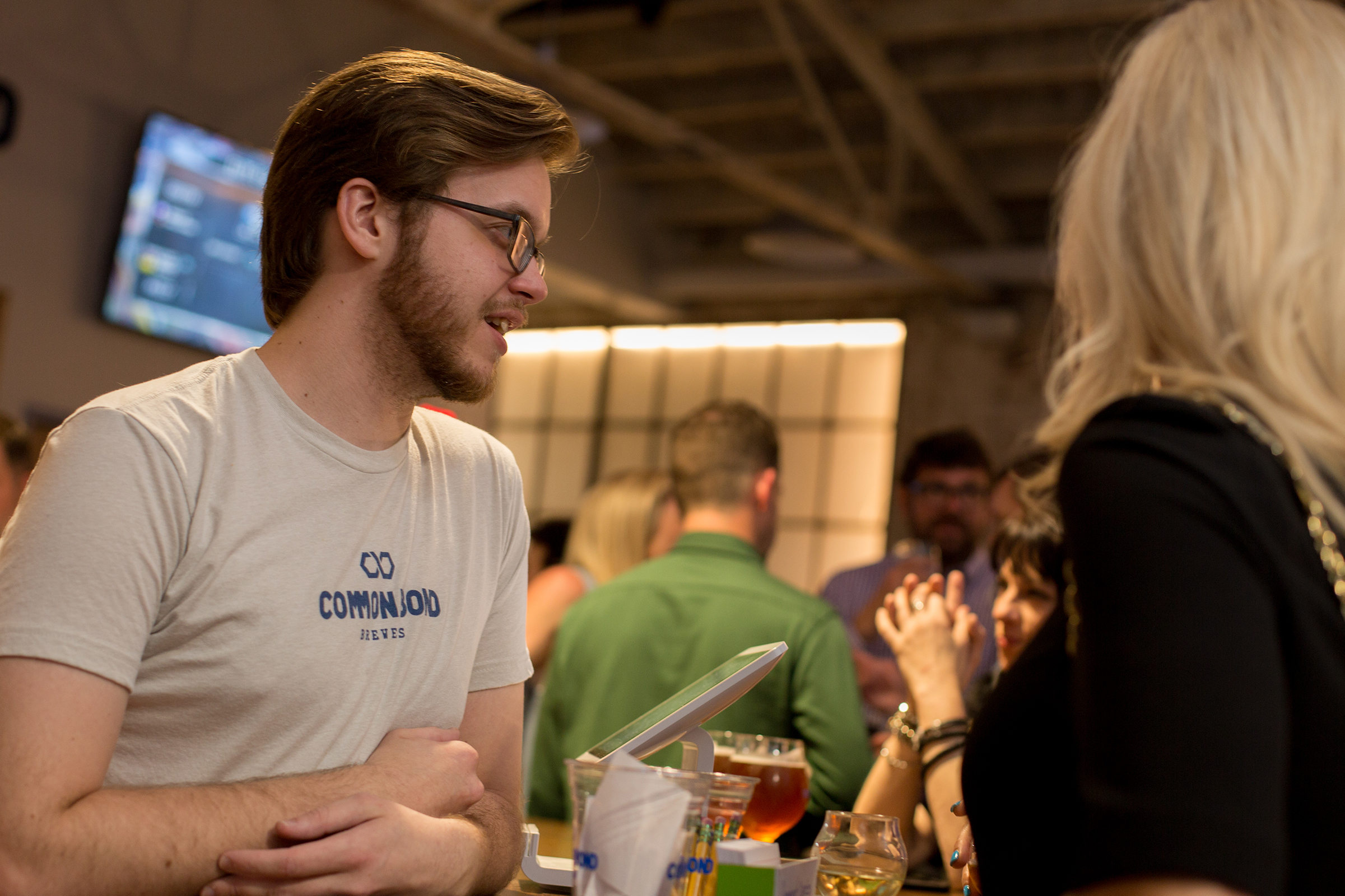 Bartender talking to customers about beer