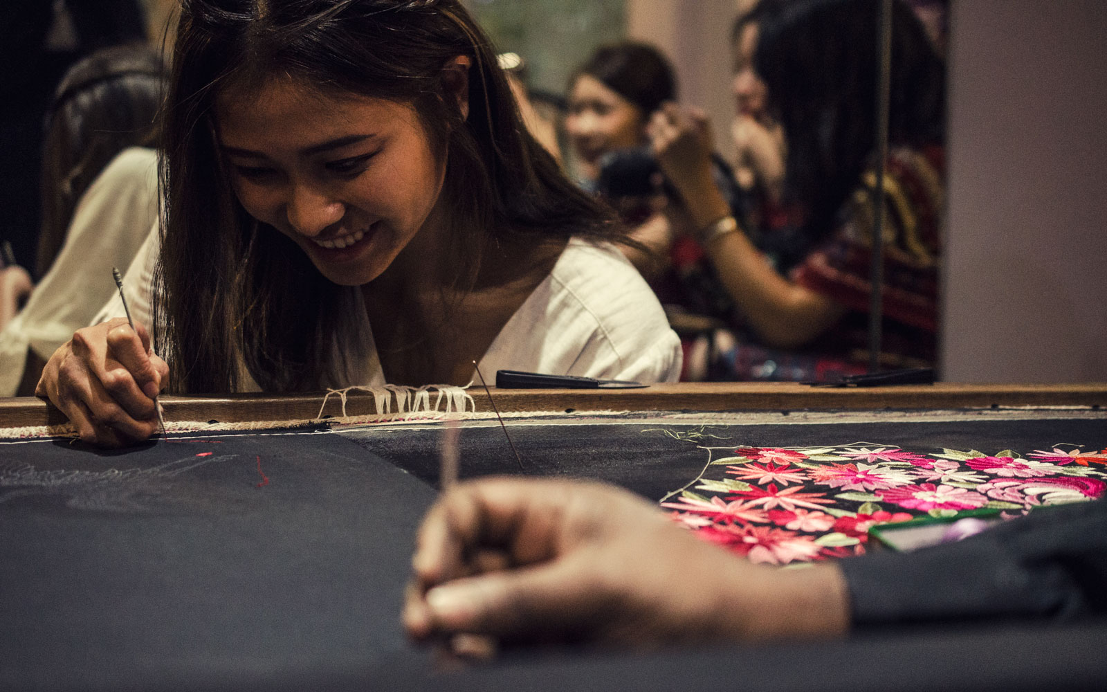  A guest tries her hand at Parsi embroidery at Ashdeen Lilaowala’s studio. 