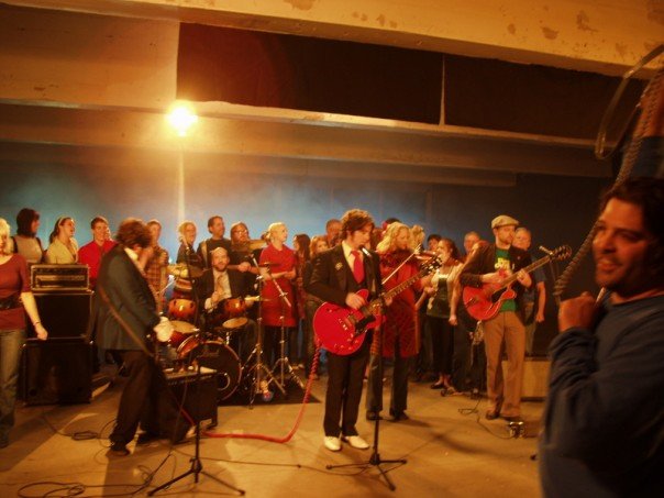 Playing guitar on the set of the film "Rainbow Around The Sun."