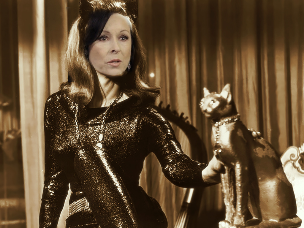   The ageless Ann Batley Burton (lady has nine lives after all) reprises the role that Julie Newmar made famous. She would have preferred Pussy Galore in a remake of Goldfinger but declined when she discovered that James Bond was going to be played b