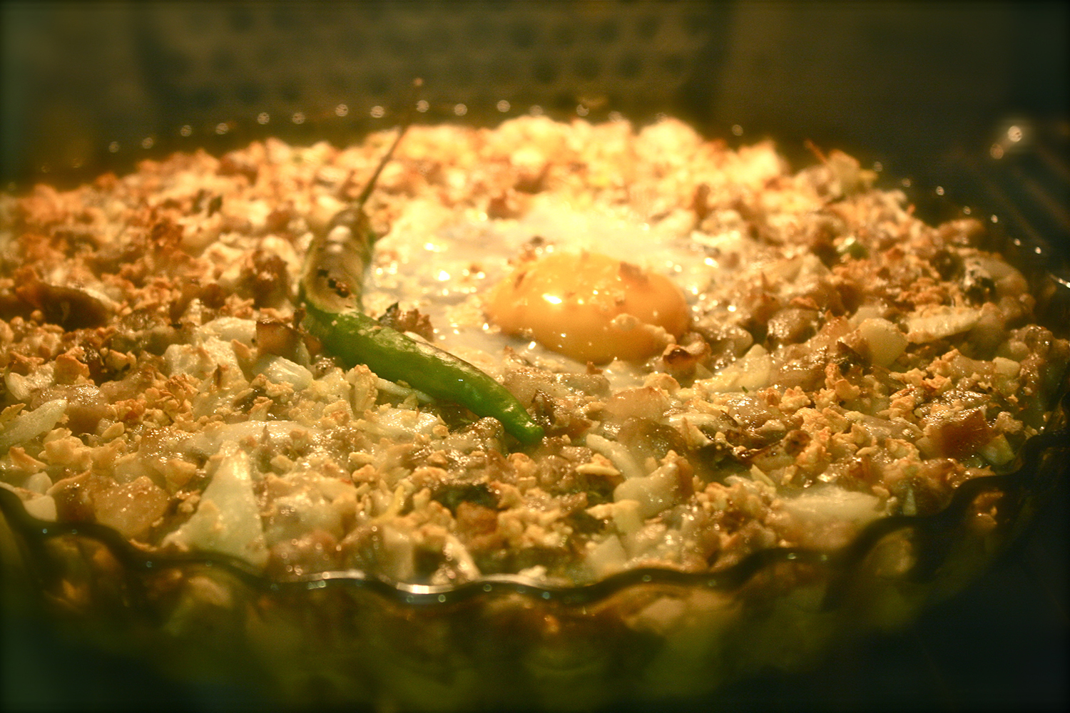  plopping an egg in the middle of the sisig 