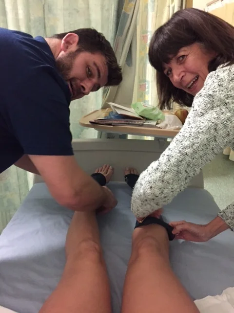 Mum and Rob pulling on my compression socks!