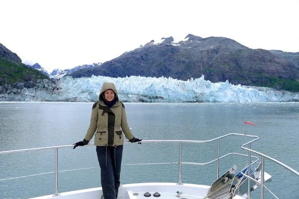 Ayla on her boat during senior year, in front of Margerie Glacier.