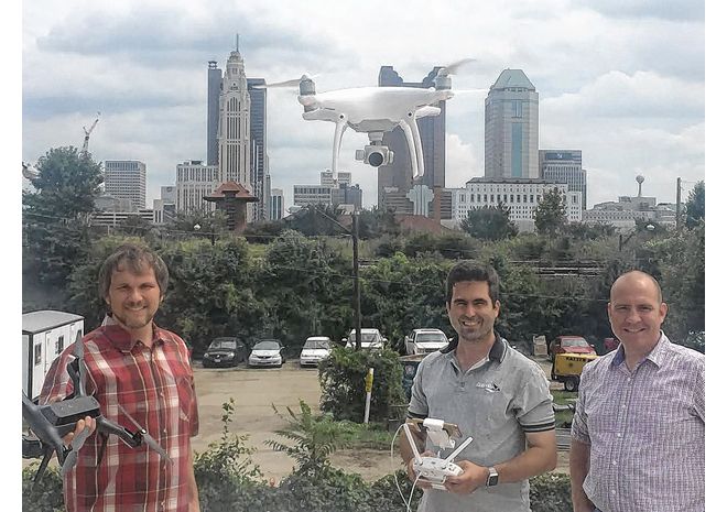 Steve Hane (center) of MetroAir Photo legally pilots his drone on the roof of the Murphy Co.'s building in Columbus, home of Autonomy Hub, while collaborators Loren Stone of the Tesla Foundation (left) and Dave Agler of Double I Media look on.