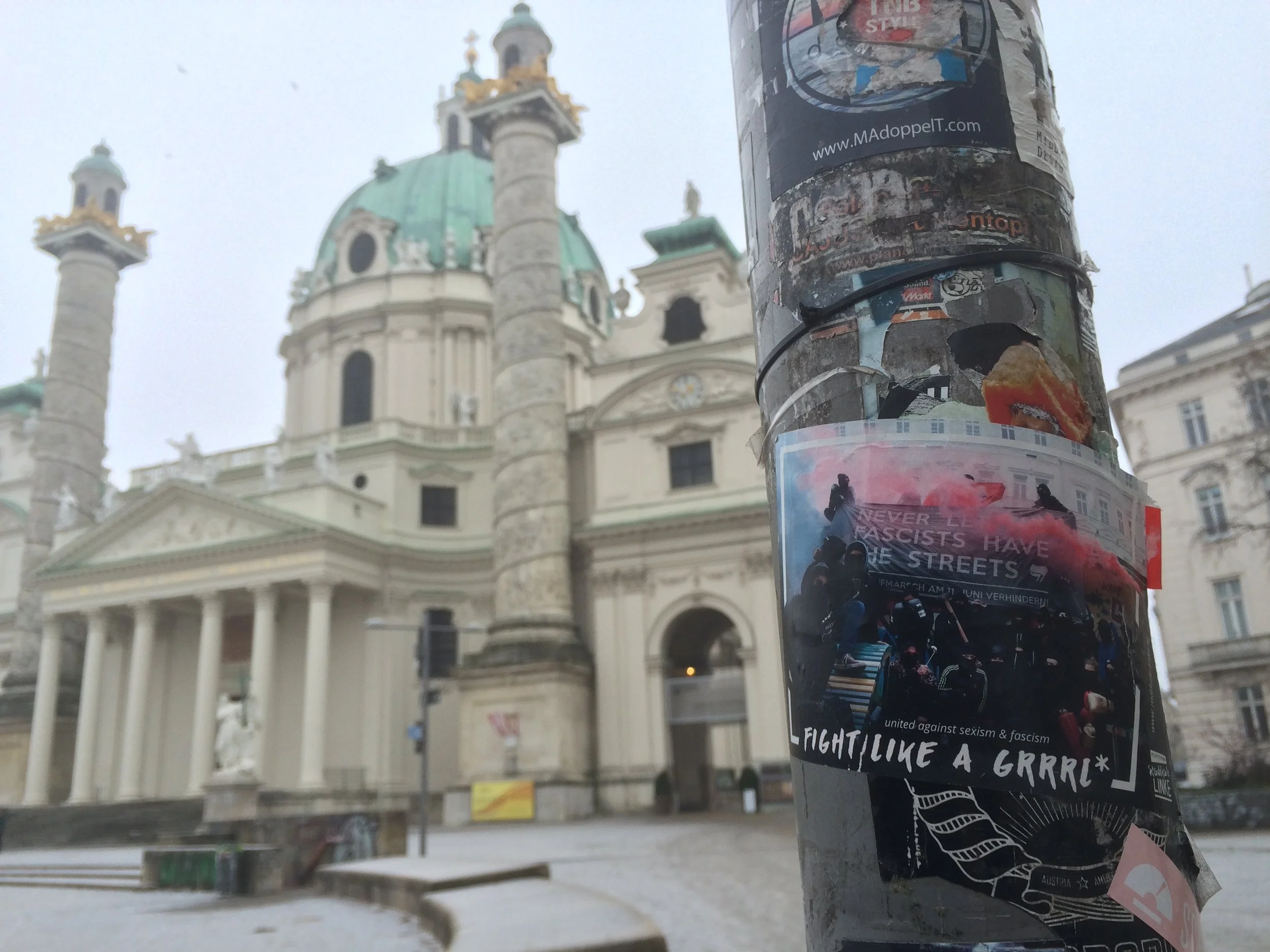 Antifascist sticker in Karlsplatz, the structure in the background is St. Charle's church.