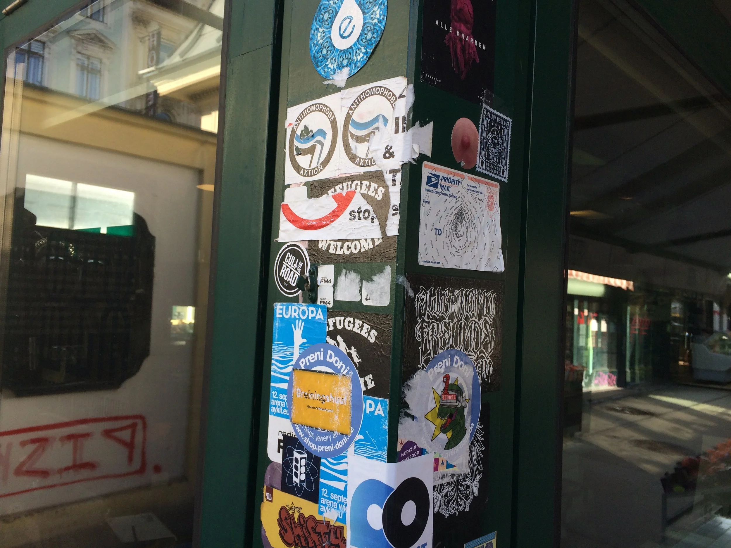 Support beam in Naschmarkt that has progressively been blanketed in stickers. Towards the upper right side of the shot you can see one variety of chimp stickers that are present throughout the city.