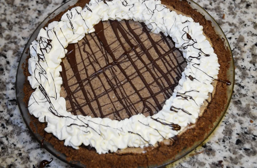 Chocolate Peanut Butter Cheesecake with drizzled chocolate on top