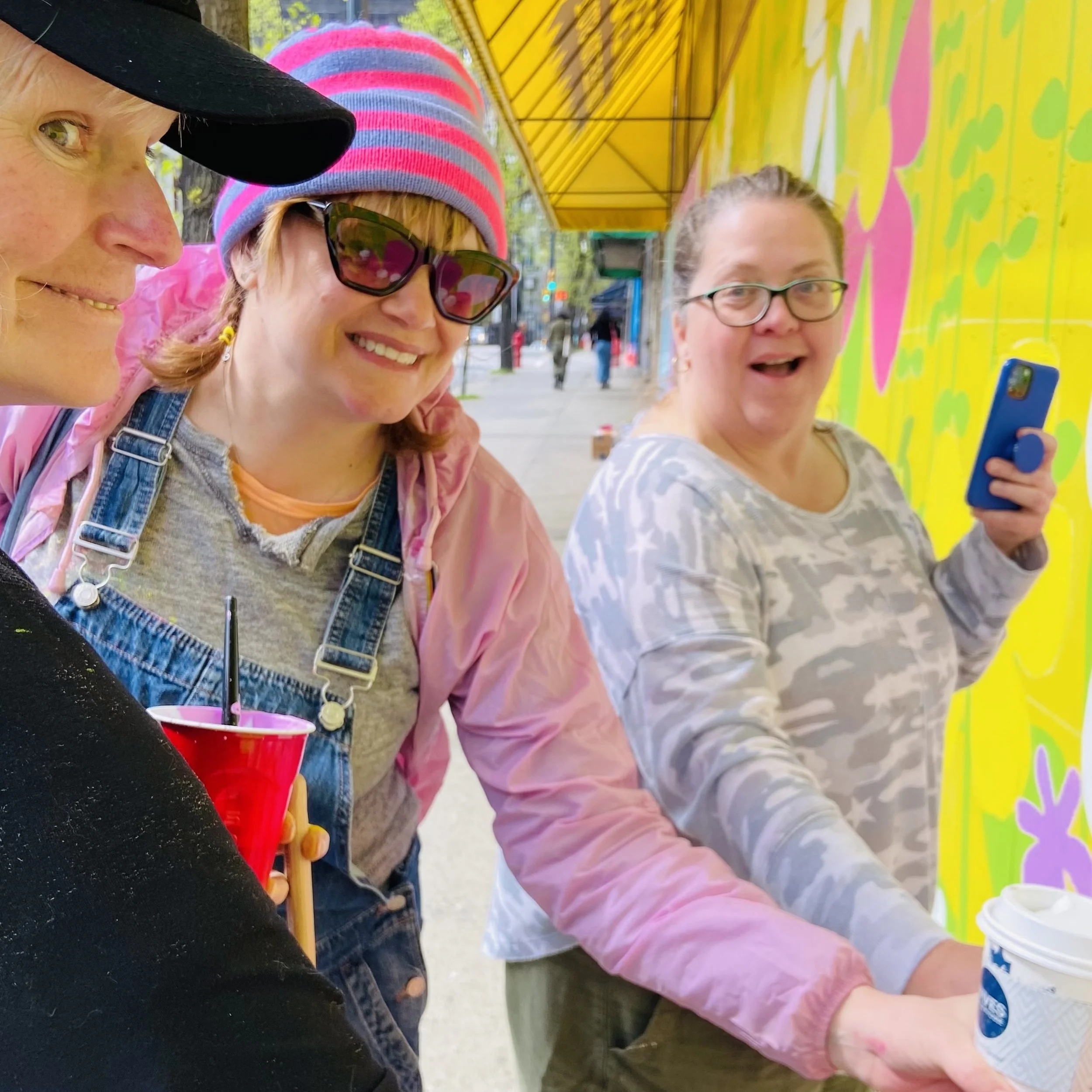 fun-ness factory: artist mastermind cohort in front of dressew mural-vancouver