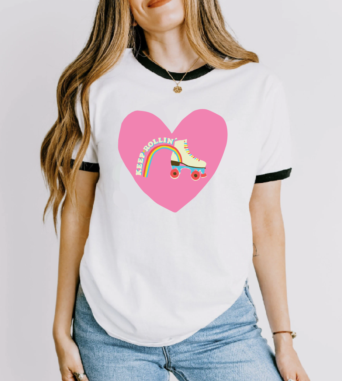 womens t-shirt keep on rollin text on a heart a roller skate with a rainbow underlining the text .png