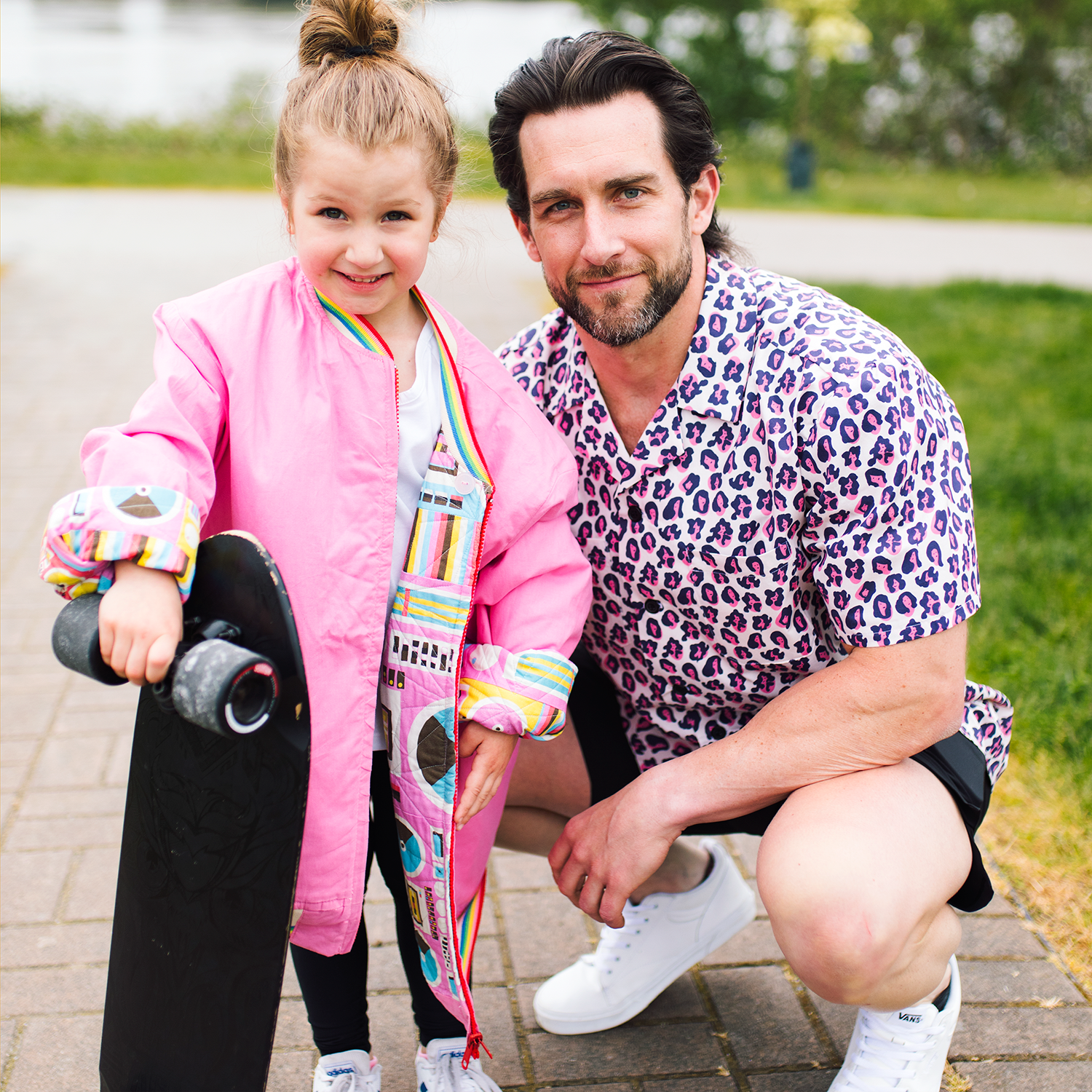 dad with daughter, she is holding a skate board he is wearing a lysa flower she is fierce mens shirt.png