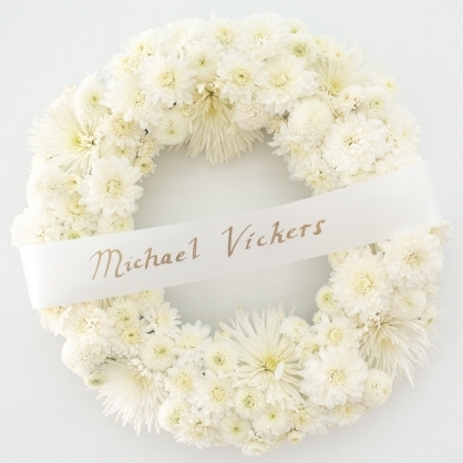 Wreath, Painted banner and floral wreath, 24 x 624 x 5 in, 2017.