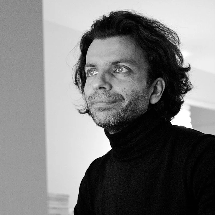 Born in Boulogne-Billancourt (Paris) in 1964, Fabrice Berrux qualified in 1986 from the National Arts School in Dijon. He started then as an interior Architect before setting up his firm “18 AOUT”, in 1987. 18 AOUT produced and distributed sensitive and playfukl objects referring to Art, such as FLOWER, a vase that was made in honour of Andy Warhol, or CHAUDFROID, a table mat inspired by Land Art. They regularly exhibited during professional shows or big events such as 30 UNDER 30 in 1989, in New York, and the European Capitals Of New Design event in 1991, at Georges Pompidou Centre in Paris. In 1991, Fabrice Berrux founded Dix Heures Dix, enlarging and re-organising 18 AOUT’s production. In 1994, he exhibited at VIA Fair in Paris By 1990, some of his products entered the collection of the Decorative Arts Museum in Paris and were sold to the shops of Modern Art Museums in Rotterdam, Dallas, Los Angeles, Chicago and George Pompidou Centre in Paris. From 1990 till 1994, he was design teacher in Dijon, Limoges and Reims, but also in Paris at the Charpentier Academy. Since 2005, he has been teaching design at the Ecole Bleue in Paris. From 1997 on, among other things, Fabrice Berrux has been developing ranges of lighting products made out of pleated-fabric, silkscreen glass, altuglas and piled-up bulbs lamps diffusing soft light … From 2002 till 2004, he was the artistic supervisor of a new collection of carpets for Serge Lesage. He also works with companies like Perigot, D’Argentat, Monnaie de Paris, Roche Bobois, Lexon and Taittinger.