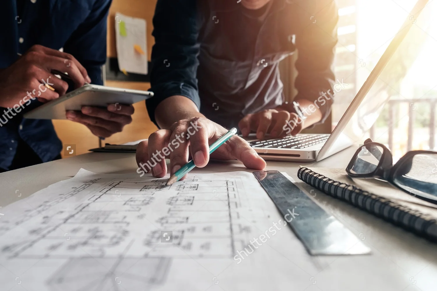 stock-photo-two-colleagues-discussing-data-working-and-tablet-laptop-with-on-on-architectural-project-at-460302868.jpg