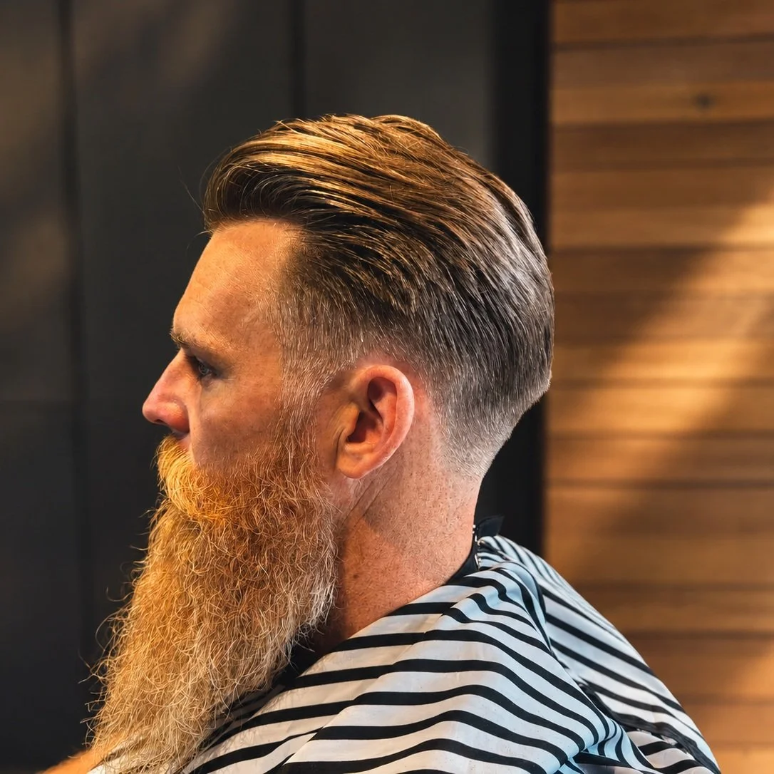 A fresh fade, a little off the top and a beard that means business. Whether you are keeping it sharp or growing something glorious, we've got you covered. UGLY Never Looked So Good.