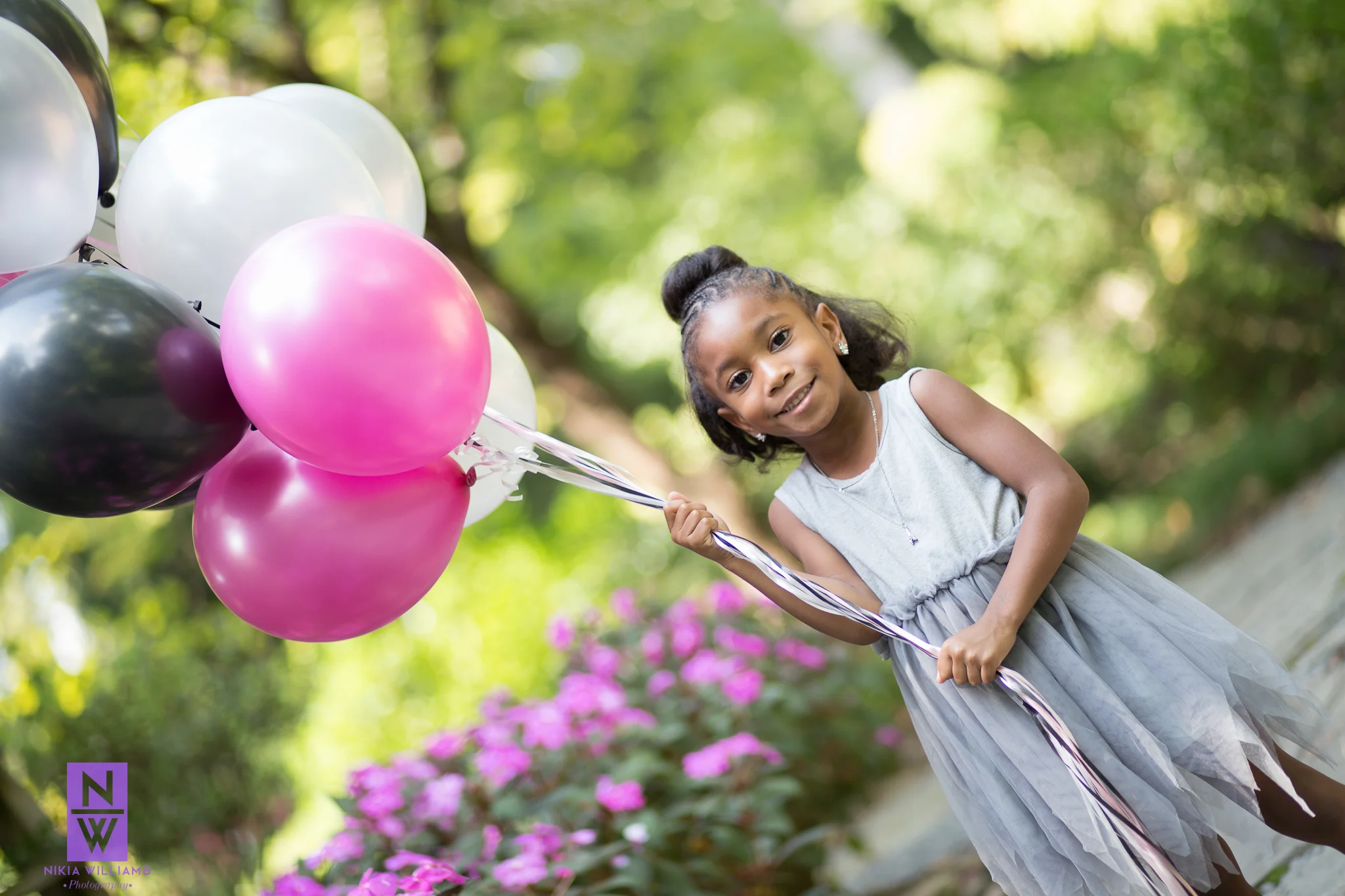 Reagan's colorful birthday balloons add a pop of color to her session! Photo By Nikia Williams