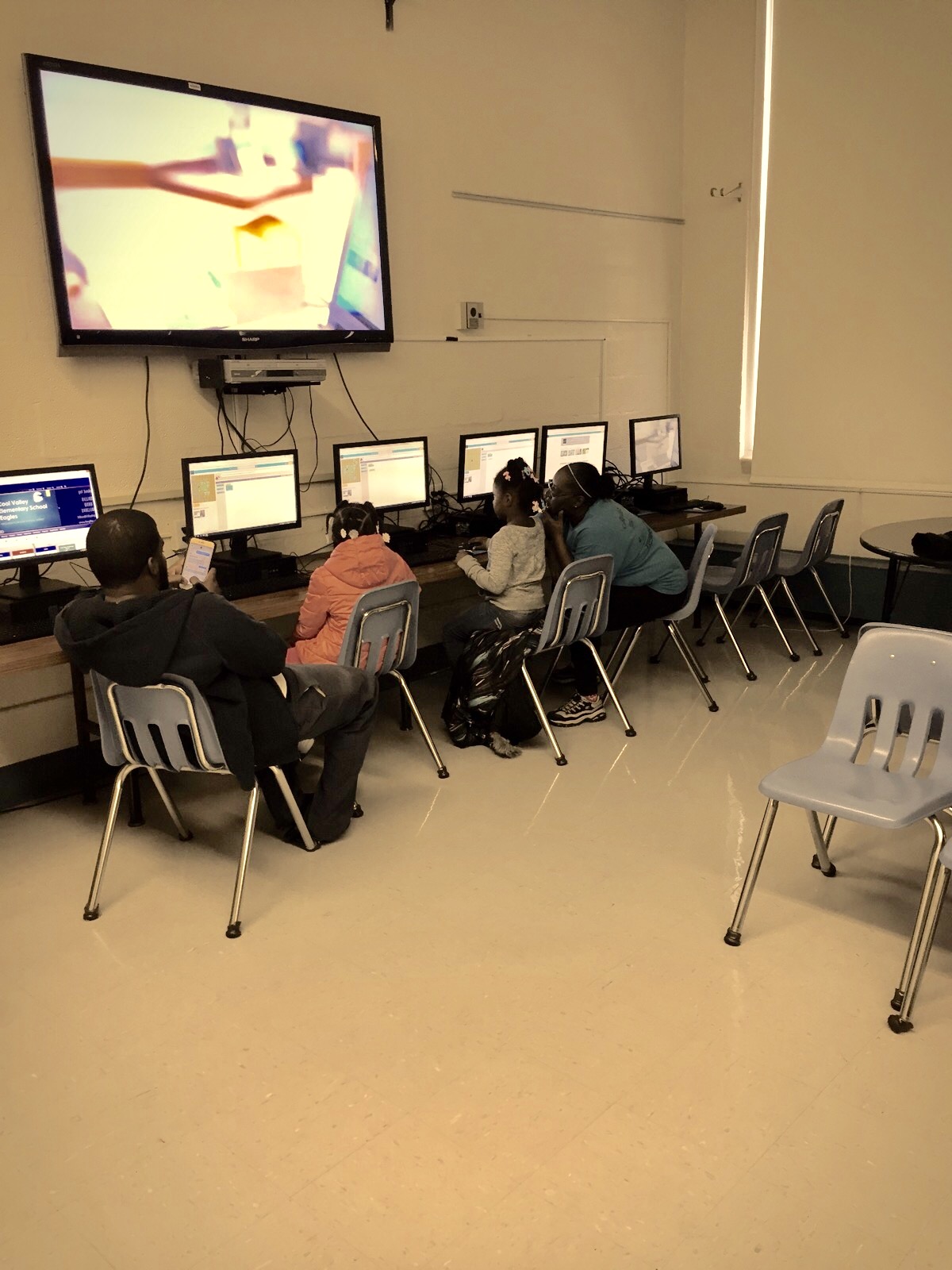Image 1: Founder, Shay Gillespie helping students with writing code. Image 2: Students writing code and understand the basic of computer programming. 