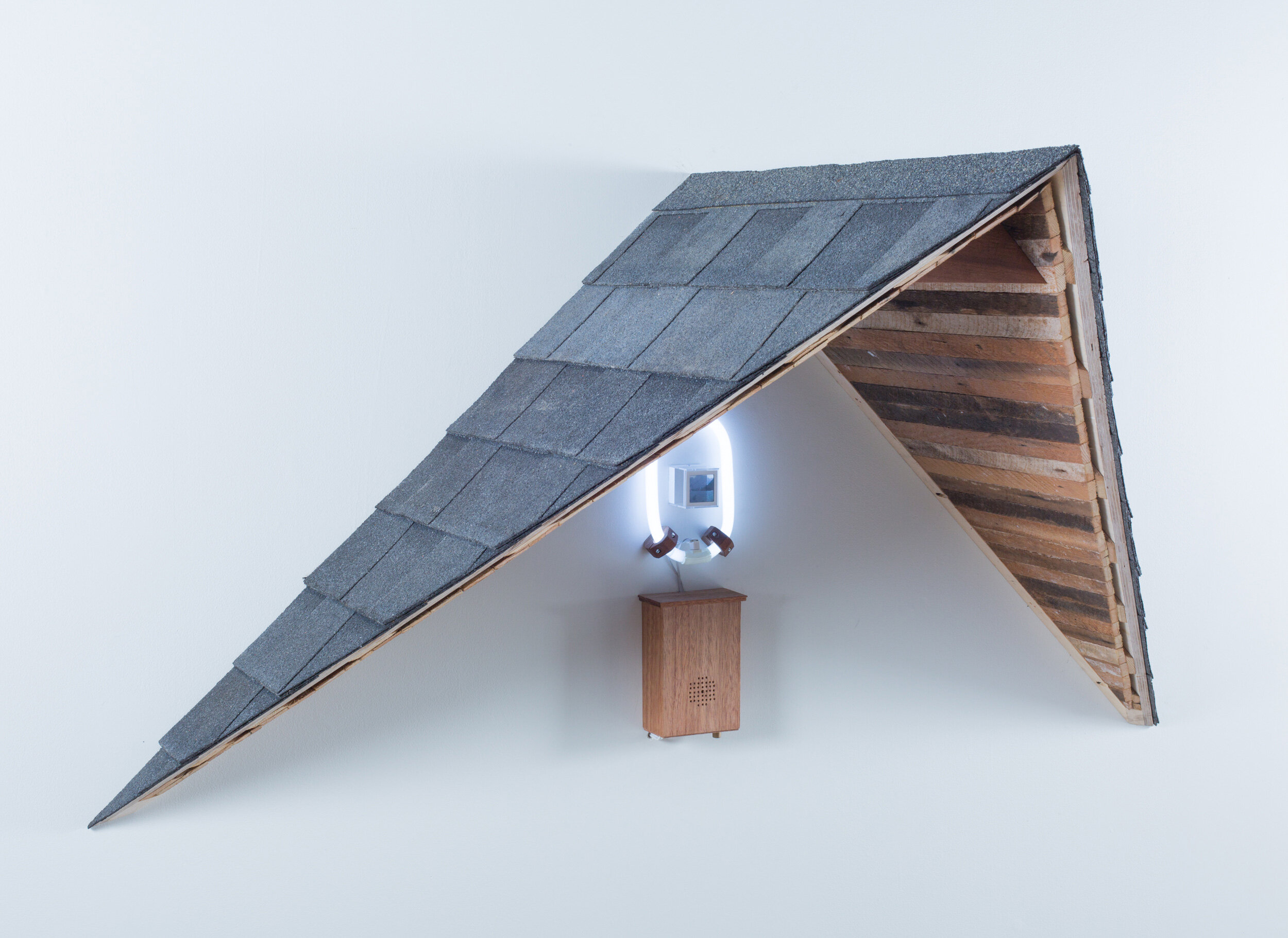   Mark Baugh-Sasaki, Uncanny Valley Color 35mm slide, Plexiglas, electronics, fluorescent light, speaker, audio recording, plywood, lath, roofing shingles 36” x 72” x 36” 2019  
