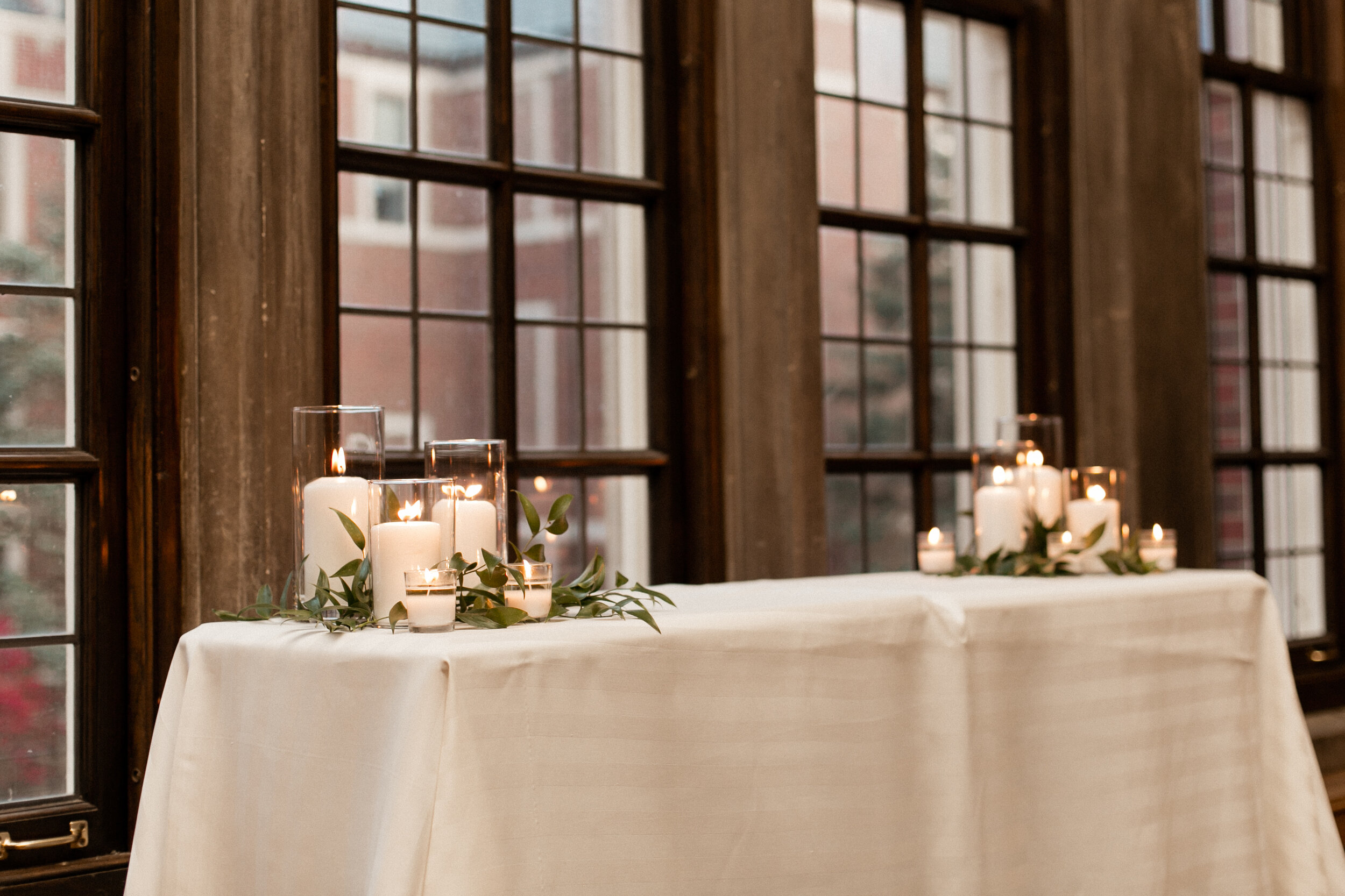pillar candles with greenery ceremony.jpg