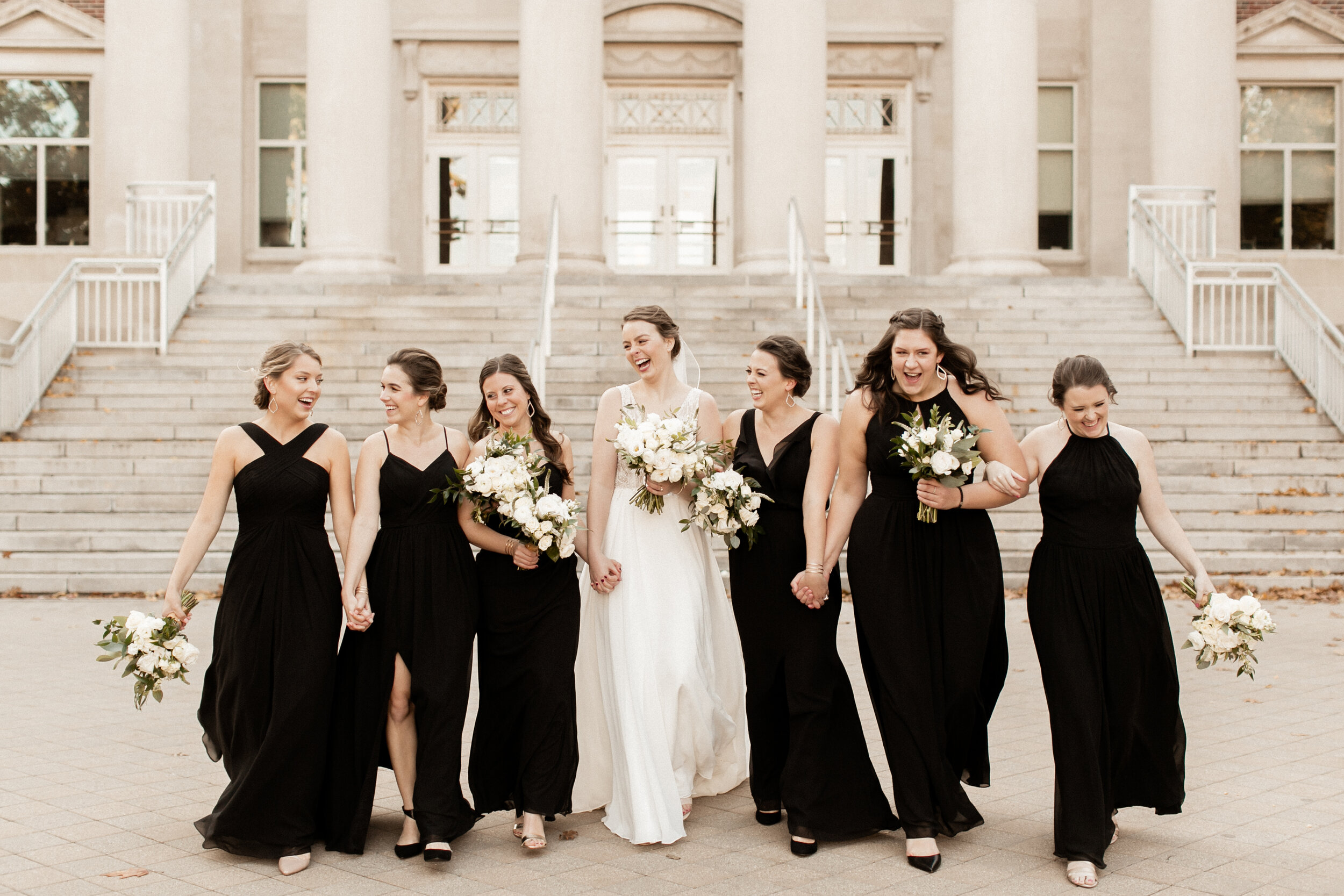 bridesmaids in black dresses with white bouquets.jpg