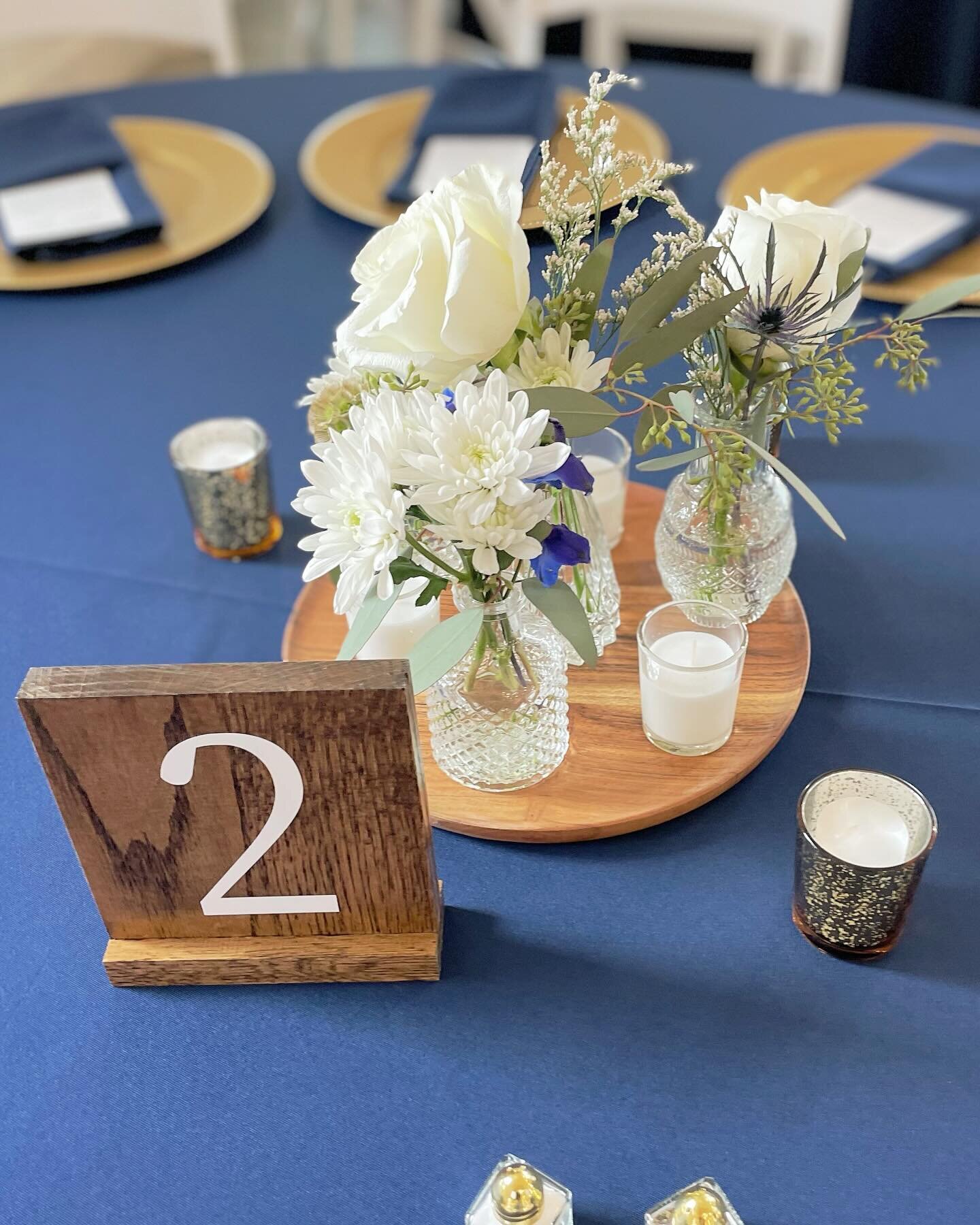 A cluster of bud vase arrangements make a great centerpiece option. White is a classic style but you can also add colorful flowers to make these pop even more!