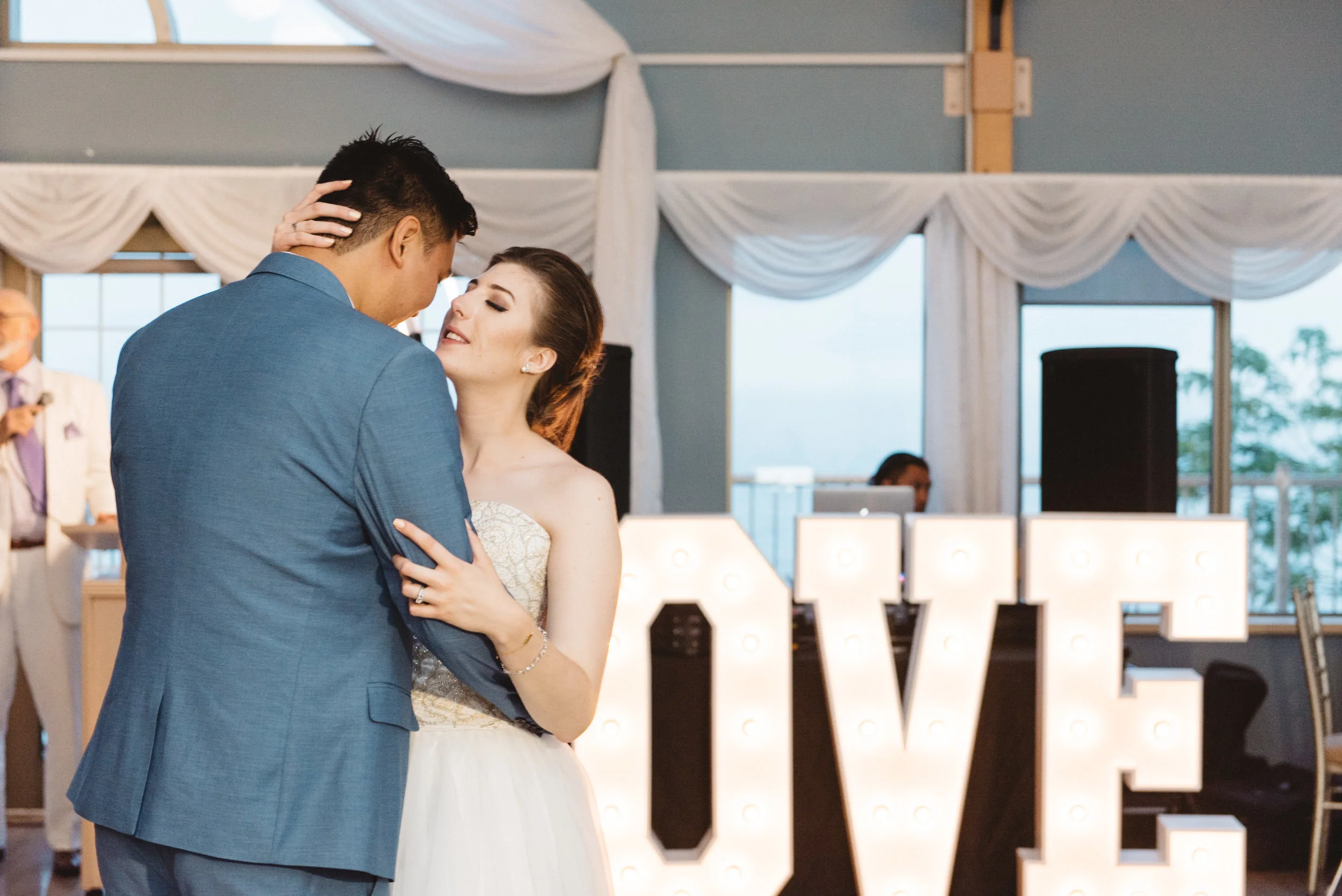 bride and groom woth love sign