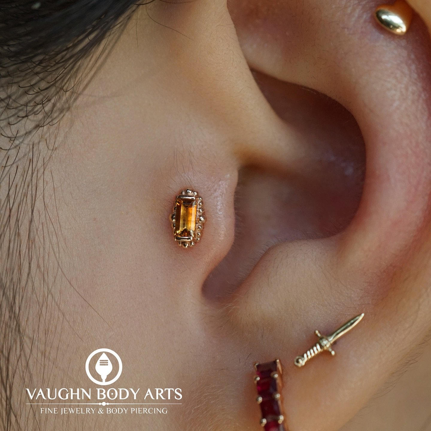 One of our absolute favorite designs for tragus piercings! 

Cody got to do this tragus for Nancy, and we were so excited she chose one of the &ldquo;Beaded Baguette&rdquo; designs from BVLA. 

The baguette-cut Genuine Citrine is the perfect shape th
