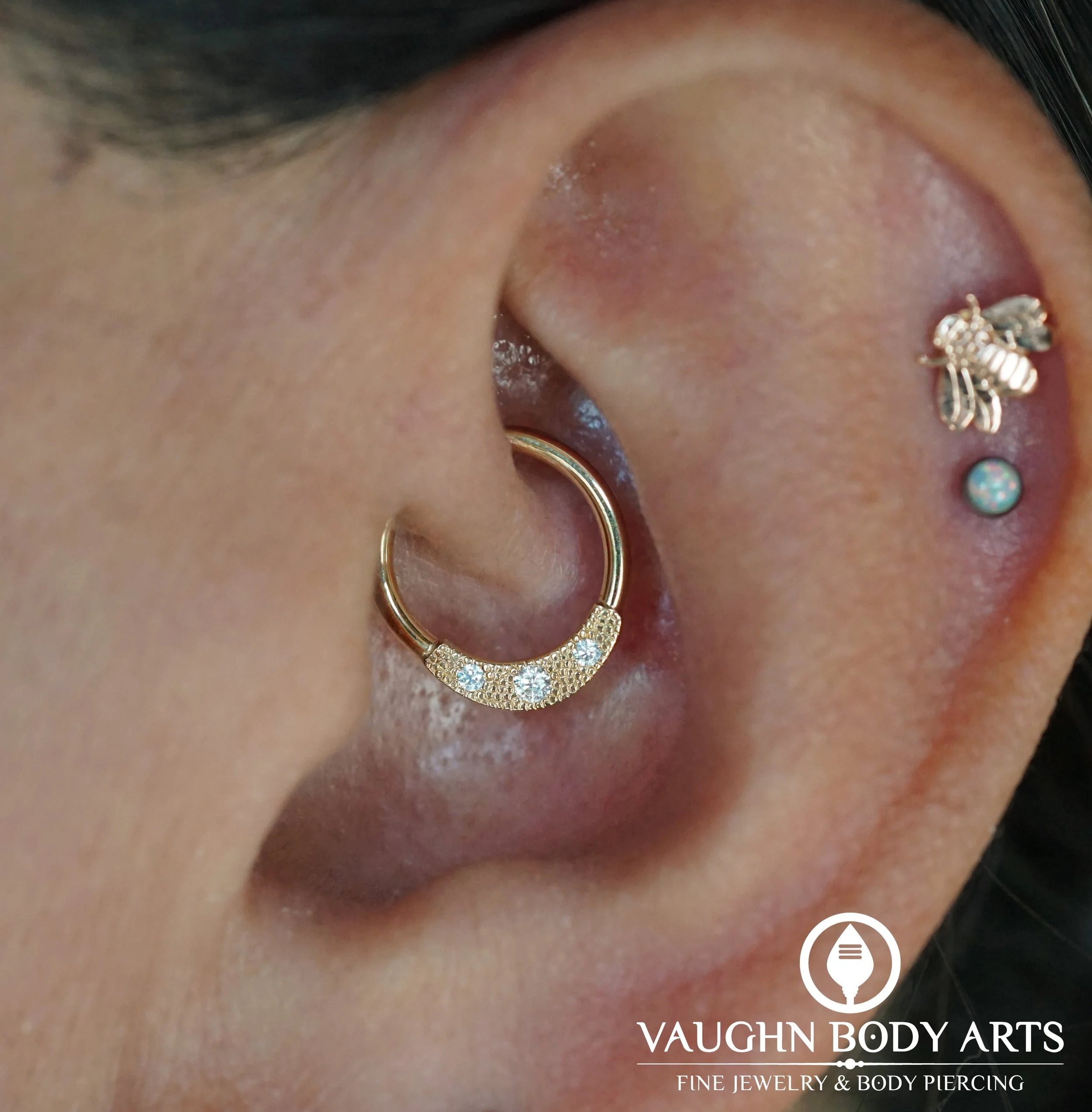 Our wonderful client Julie stopped by to pick out something new for her healed daith piercing. 

She chose this gorgeous Janna seam ring from BVLA. We love the texture around the gemstones that the pave setting adds. Definitely one of our favorite de