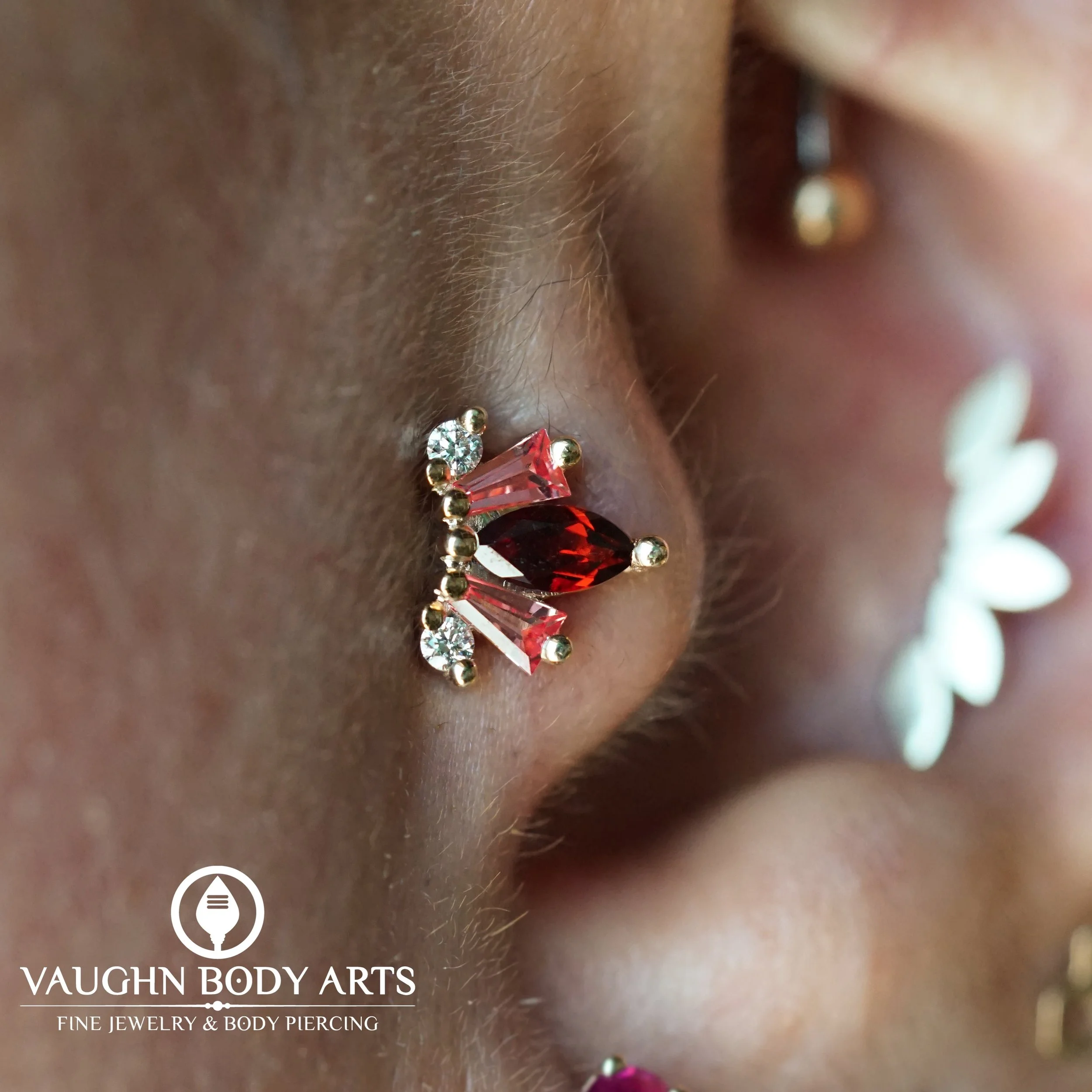 Needless to say, Jessica has got damn good taste. 

Jessica had Vaughn do a new tragus piercing for her. She chose this jaw dropping &ldquo;La Princesa&rdquo; from BVLA. 

Solid Yellow Gold with a Garnet, Padparadscha Sapphires, and Diamonds. 

Thank