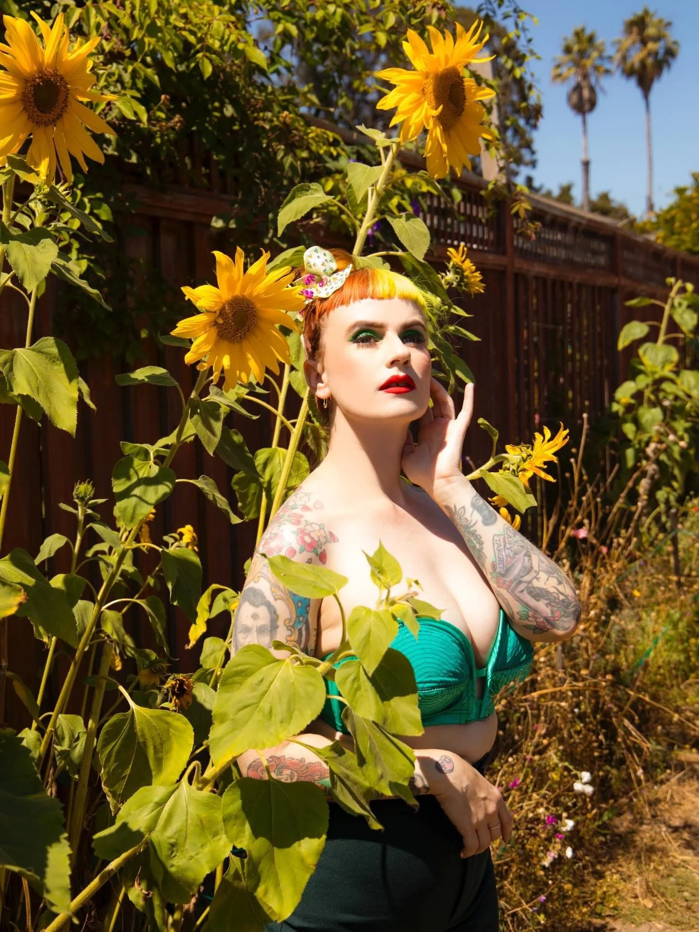 An artistic portrait of a tattooed model with retro vintage style colorful makeup